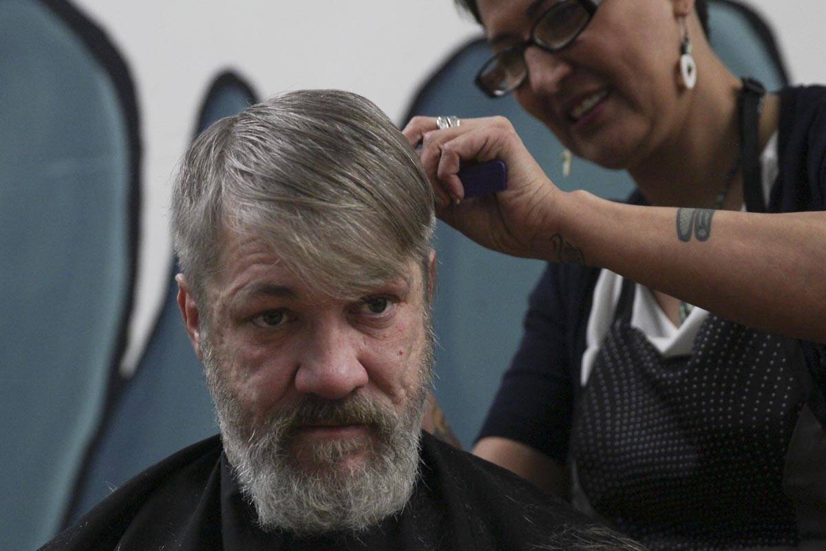 Steven Lythgoe gets his hair cut by Jamiann Hasselquist at the Zach Gordon Youth Center during the Juneau Coalition for Housing and Homelessness’ 9th annual Homeless Connect event, Jan. 29, 2020. (Michael S. Lockett | Juneau Empire)