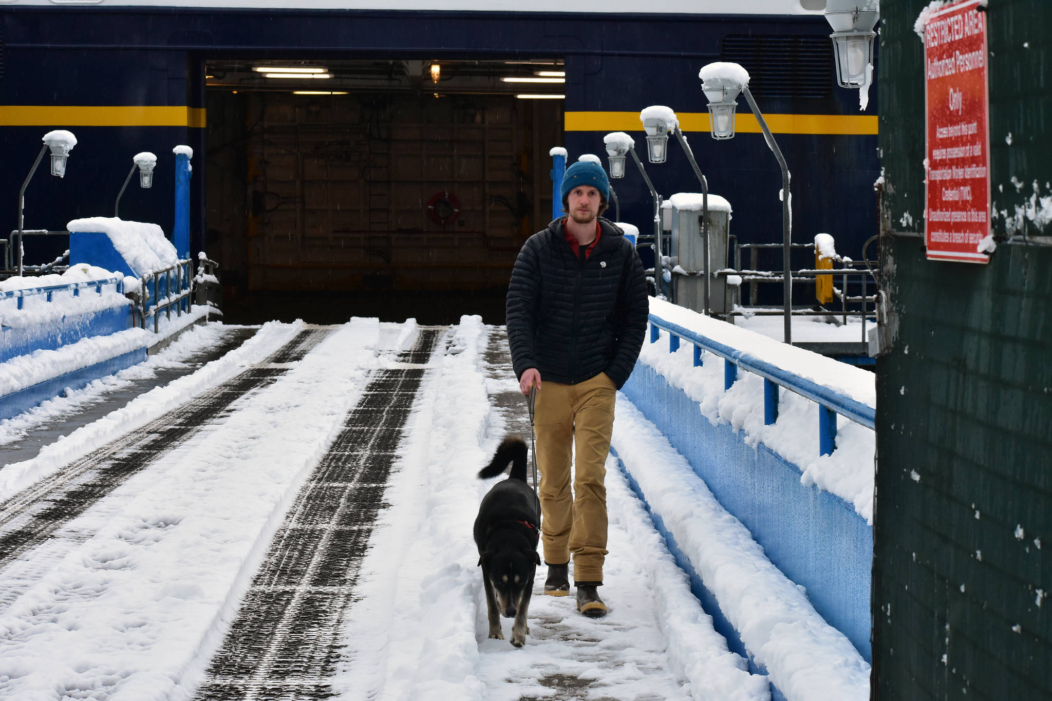 Keegan Krantz, 30, and his dog Nootka on the loading ramp to the FMV Matanuska on Thursday. (Peter Segall | Juneau Empire)