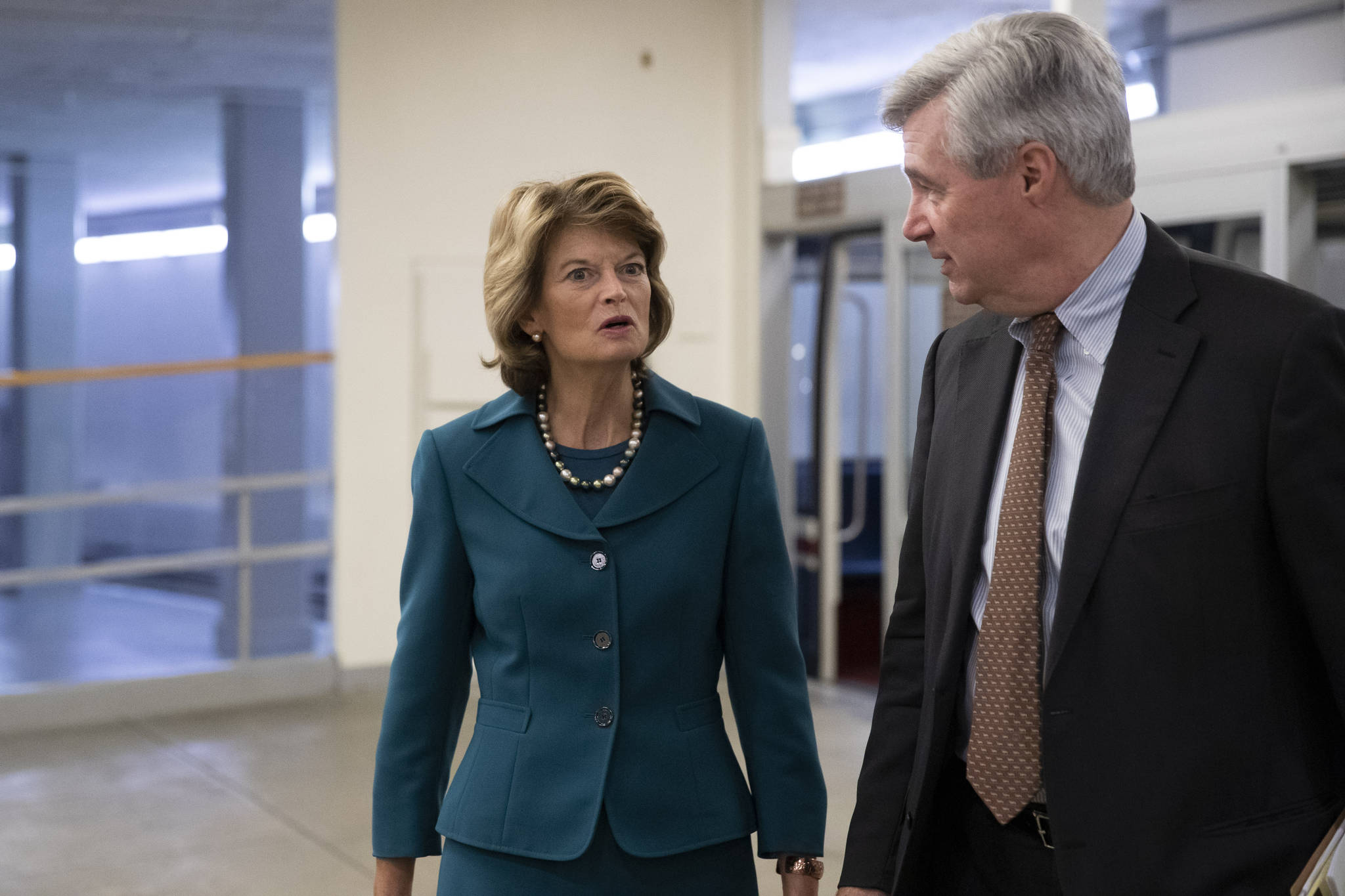 Sen. Lisa Murkowski, R-Alaska, left, and Sen. Sheldon Whitehouse, D-R.I., walk on Capitol Hill, Tuesday in Washington. (AP Photo | Alex Brandon)