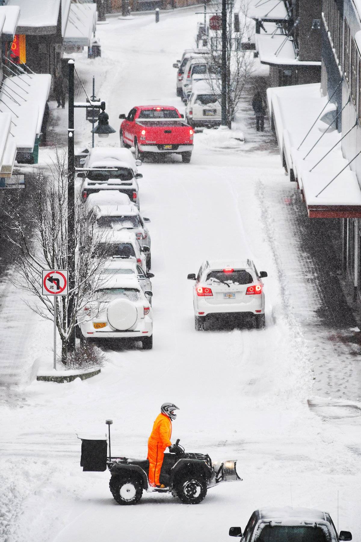 A Juneau city employee plows sidewalks along Seward Street with an ATV in February 2019. (Michael Penn | Juneau Empire File)