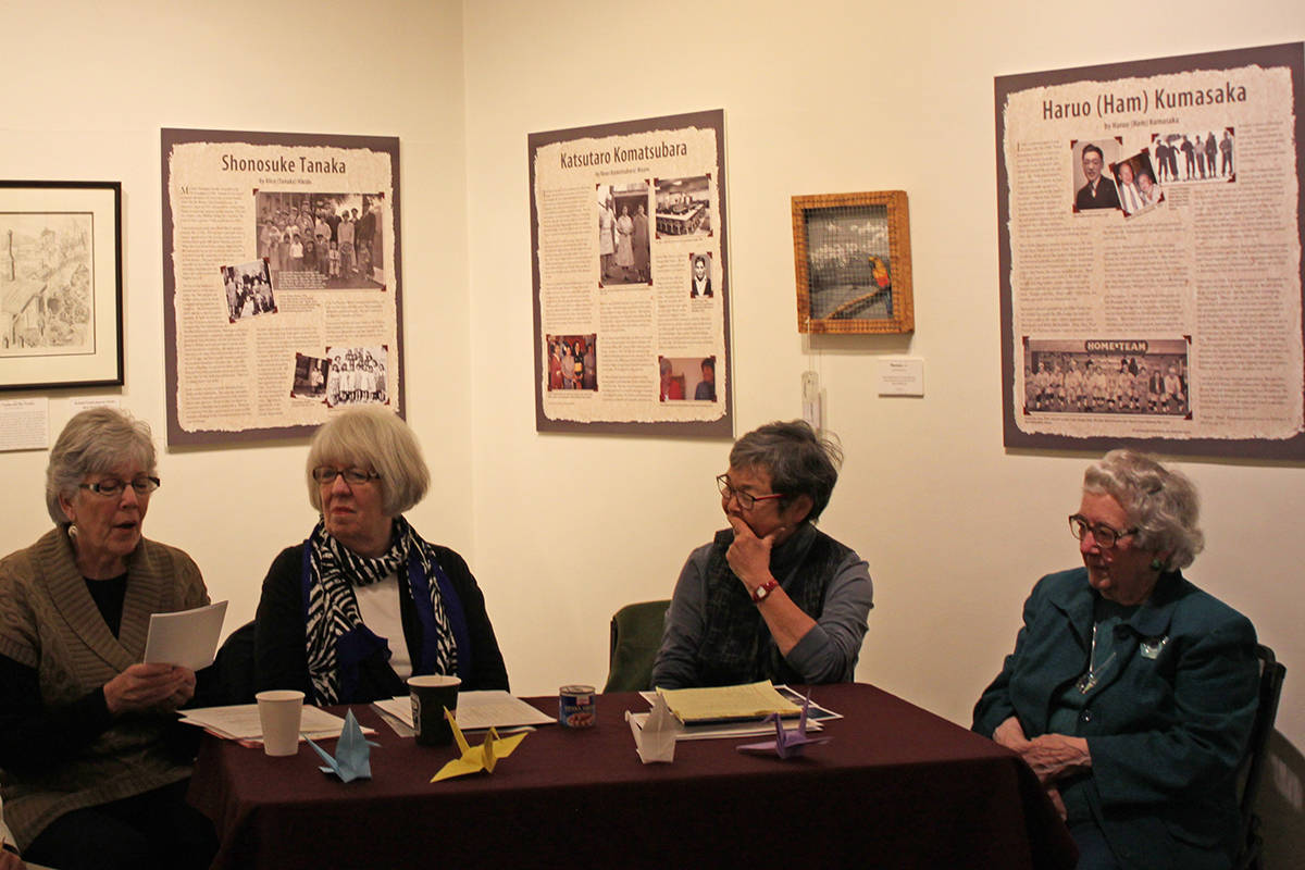 From right to left, Karleen Grummett, Marjorie Alstead Shakelford, Mary Tanaka Abo and Marie Darlin discuss the “Empty Chair” exhibit at the Juneau-Douglas City Museum on Saturday, Oct. 11, 2014. The exhibit will be at the museum through the end of the month. (Stephanie Shor | Juneau Empire)