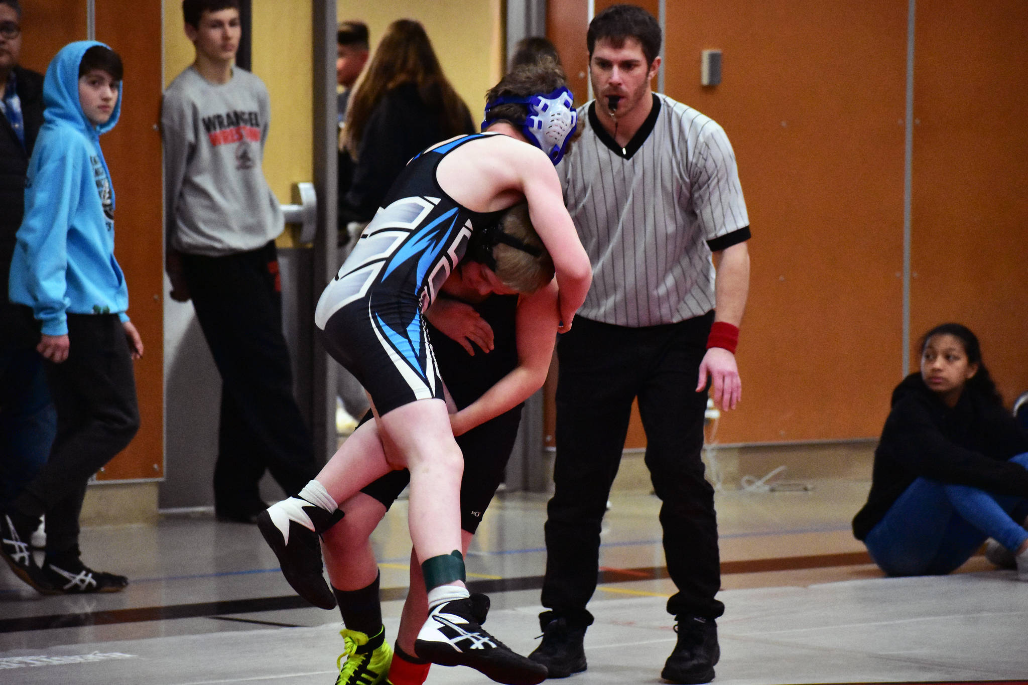 A referee watches as students wrestle at the 2020 Southeast Alaska Middle School Wrestling Tournament at Floyd Dryden Middle School on Friday. (Peter Segall | Juneau Empire)