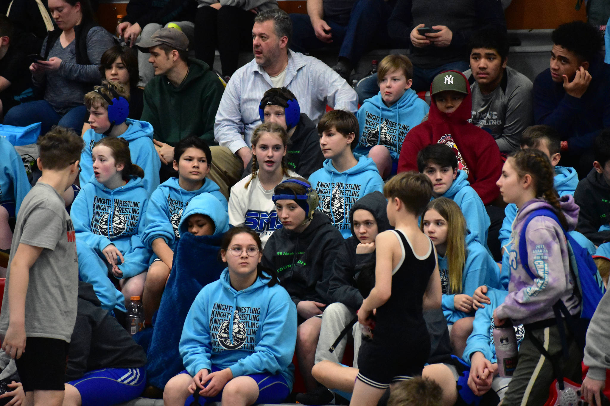Visiting students watch from the stands at Floyd Dryden Middle School during the 2020 Southeast Alaska Middle School Wrestling Championship on Friday. (Peter Segall | Juneau Empire)