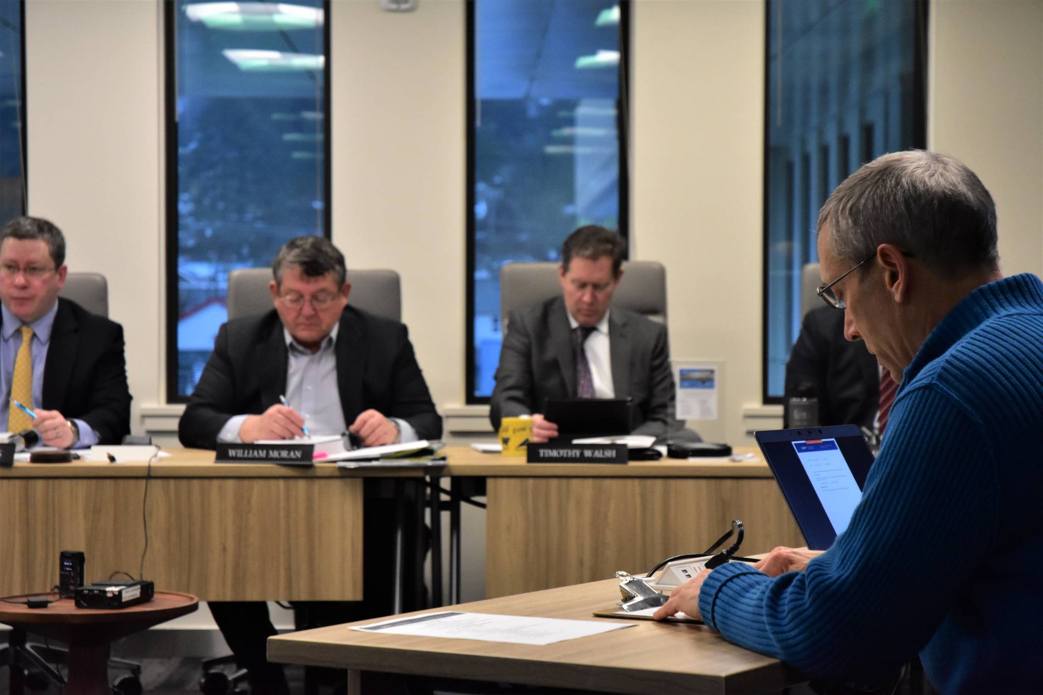 Doug Woodby, co-chair of environmental group 350Juneau, right, gives public testimony to the Alaska Permanent Fund Corporation Board of Directors at their quarterly meeting on Wednesday. (Peter Segall | Juneau Empire)