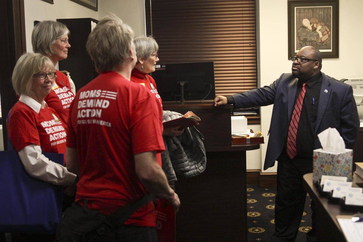 Members of Moms Demad Action for Gun Sense in America talk to a staffer about House Bill 62. (Michael S. Lockett | Juneau Empire)