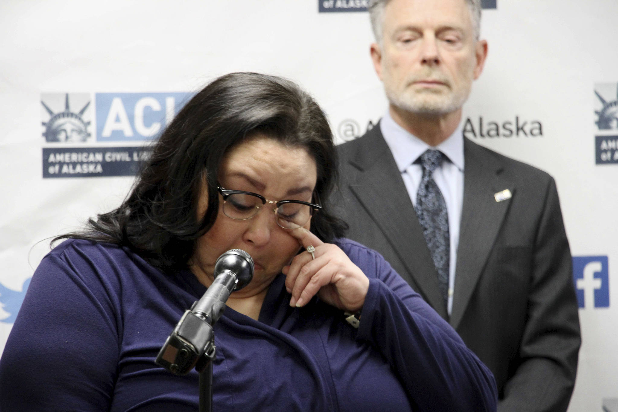 Clarice Hardy wipes a tear away from her eye during a news conference Thursday in Anchorage. The American Civil Liberties Union of Alaska filed a lawsuit Thursday on Hardy’s behalf against the City of Nome and two former officers for failing to investigate the sexual assault report filed by Hardy, a former police dispatcher. On the right is Stephen Koteff, the ACLU’s legal director in Alaska. (AP Photo | Mark Thiessen)