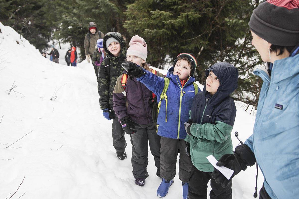 Teacher Diane Antaya talks to a group of 2nd graders from Harborview Elementary School about the states of water during a nature hike supported by Discovery Southeast near the Mendenhall Glacier Visitor Center on Feb. 20, 2020. (Michael S. Lockett | Juneau Empire)