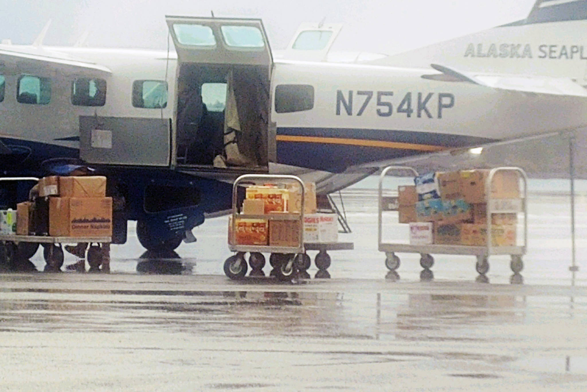 Donated food bound for Kake being loaded onto a plane in Sitka. (Courtesy photo | Paulette Moreno)