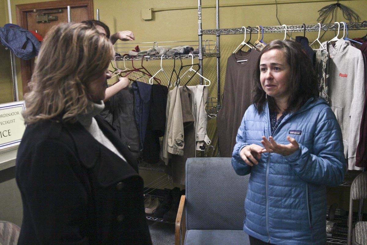 Heather Handyside, left, GCI’s vice president of corporate communication and community engagement, speaks to Mariya Lovishchuk, executive director of the Glory Hall, about the shelter’s needs during a visit on Friday. (Michael S. Lockett | Juneau Empire)