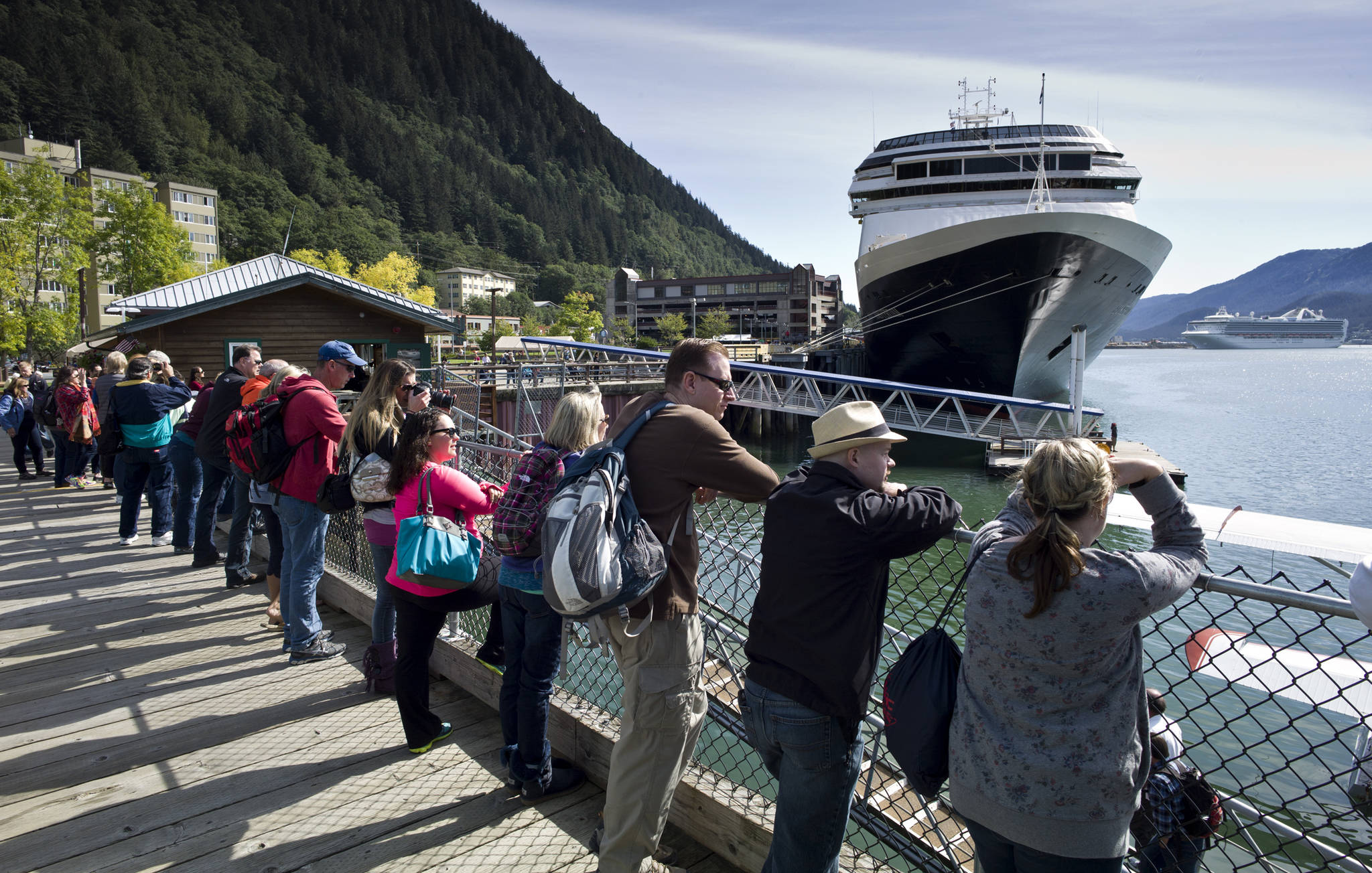 Visitors line up to view Juneaus downtown harbor in August 2015. (Michael Penn | Juneau Empire File)