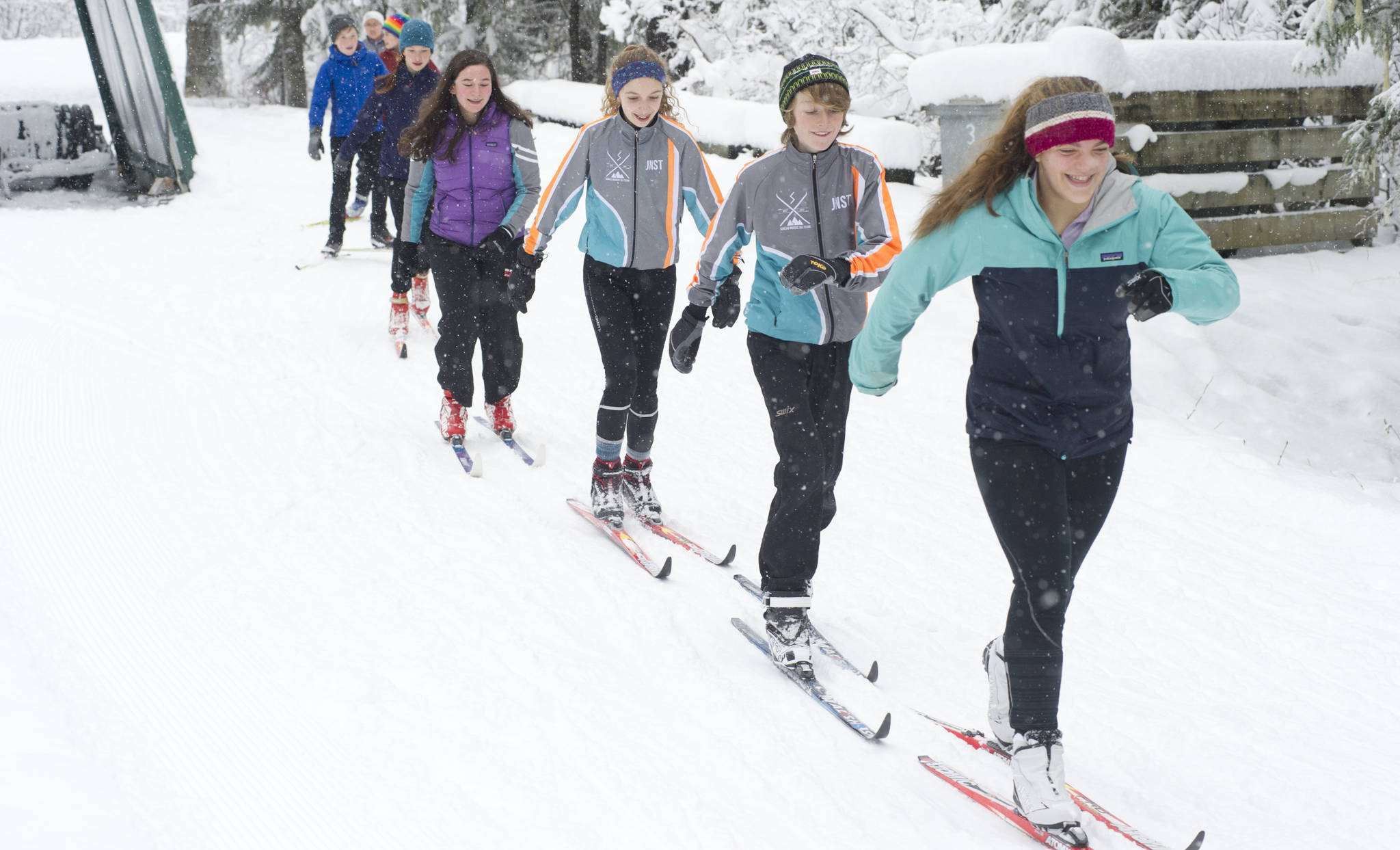 Juneau Nordic Ski Team members Erin Wallace, front, leads Aaron Blust and Anna Iverson in a pole-less skiing drill through fresh snow on Saturday, Nov. 18, 2017, at the Mendenhall Campgrounds. (Nolin Ainsworth | Juneau Empire File)