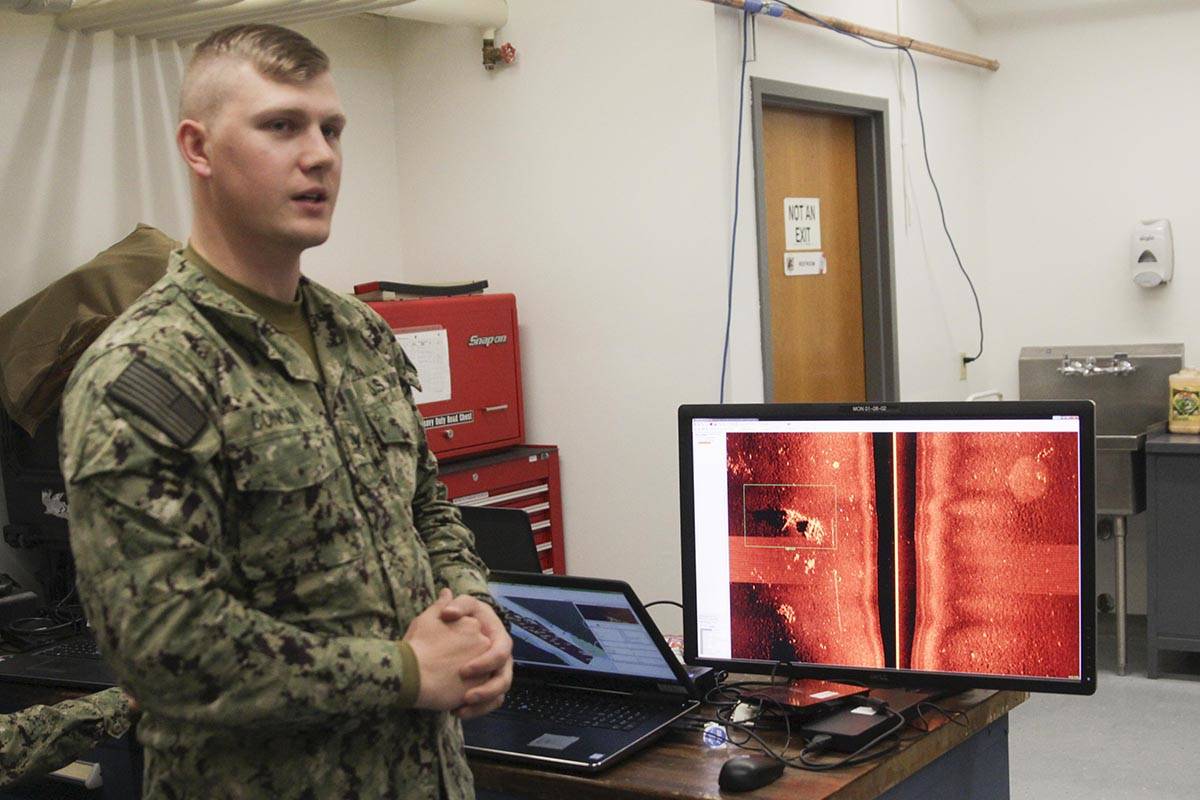 photos by Michael S. Lockett | Juneau Empire                                 Navy Petty Officer 2nd Class Derek Conklin, an unmanned underwater vehicle operator, shows the imagery of Juneau’s seafloor scanned with the UUV’s sonar at Coast Guard Station Juneau on Saturday.