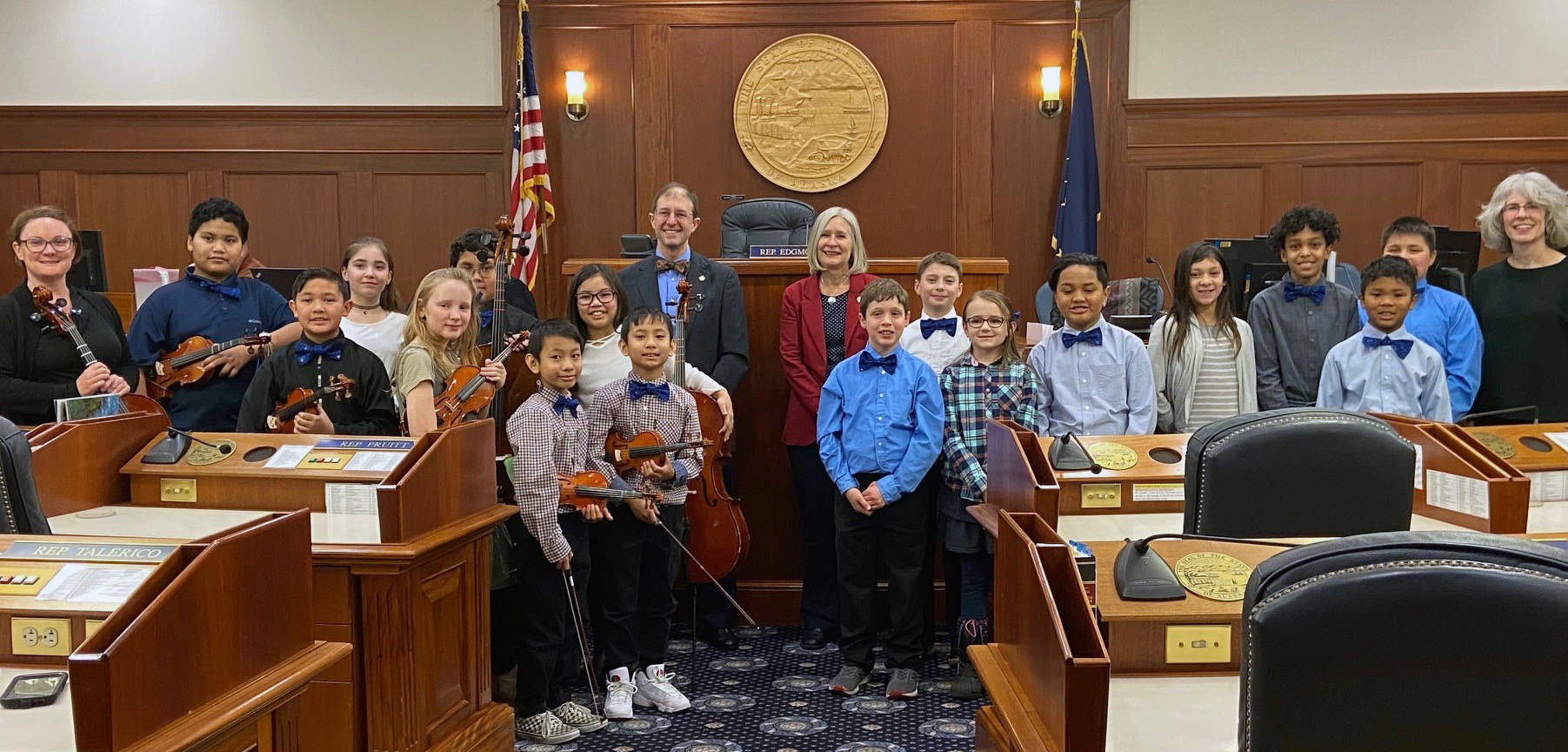 Fourth- and fifth-grade students stand in Alaska State Capitol after performing the sate song, “Alaska’s Flag,” on the first day of the legislative session. Glacier Valley Elementary School Sít’ Eetí Shaanáx music teacher Lorrie Heagy stands on the far right side of the line. Sen. Jesse Kiehl and Rep. Andi Story, both Juneau Democrats, stand in the middle. (Courtesy Photo | Lorrie Heagy)
