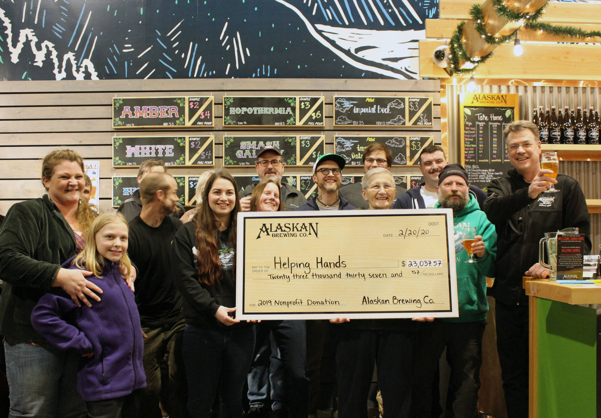 Courtesy Photo | Betty Kaplor                                 Alaskan Brewing Co. presented Helping Hands with a donation during a celebration and toast at their tasting room on Thursday.