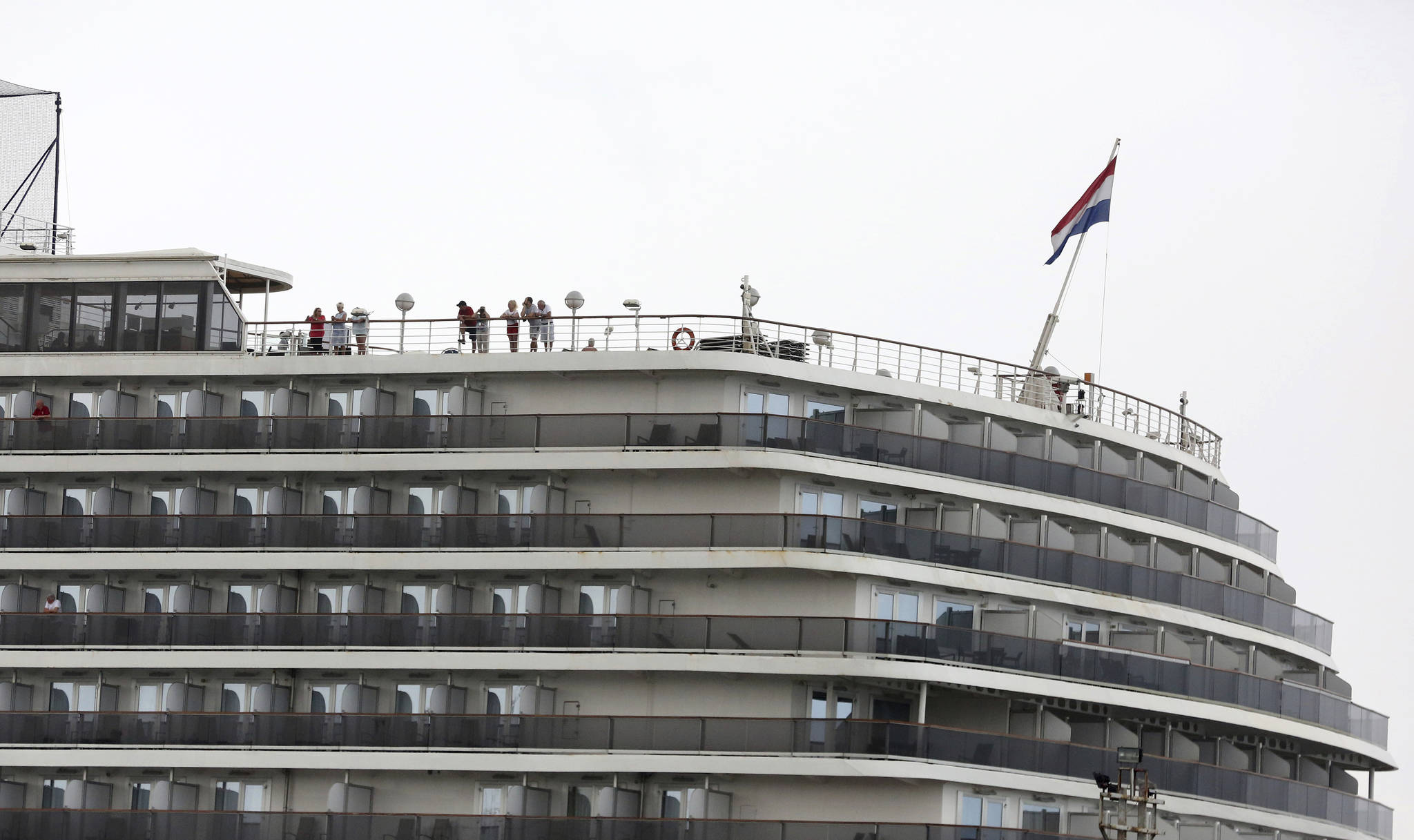Passengers stand on the top deck of the MS Westerdam while the cruise ship is docked in Sihanoukville, Cambodia Monday, Feb. 17, 2020. (AP Photo)
