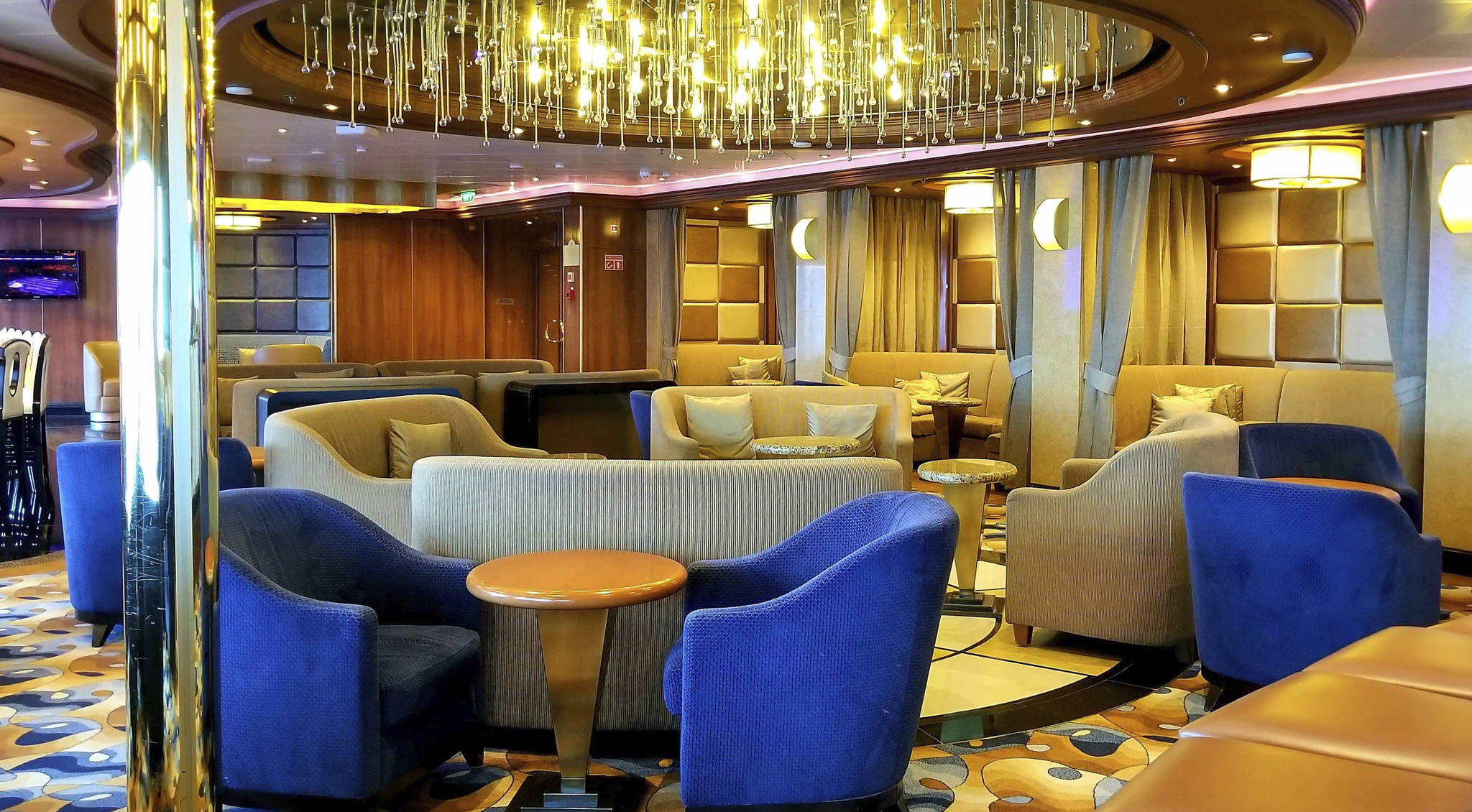 This photo provided by Michele Smith, shows an empty lounge area on the Grand Princess cruise ship Friday, March 6, 2020, off the California coast. Scrambling to keep the coronavirus at bay, officials ordered a cruise ship with about 3,500 people aboard to stay back from the California coast until passengers and crew can be tested, after a traveler from its previous voyage died of the disease and at least two others became infected. A Coast Guard helicopter lowered test kits onto the 951-foot (290-meter) Grand Princess by rope as the vessel lay at anchor off Northern California, and authorities said the results would be available on Friday, March 6, 2020. Princess Cruise Lines said fewer than 100 people aboard had been identified for testing. (Michele Smith via AP)