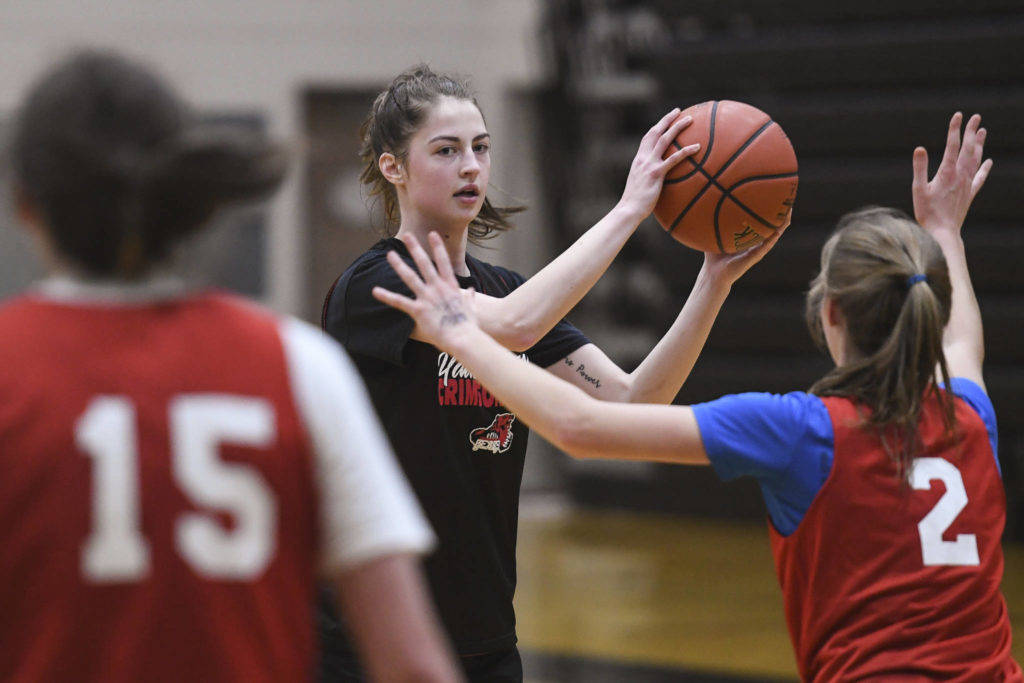 Kendyl Carson, center, looks to pass against Skylar Tuckwood, right, during girls varsity basketball practice at Juneau-Douglas High School: Yadaa.at Kalé on Monday, Dec. 9. Carson paced JDHS in an early tournament win in Anchorage. (Michael Penn | Juneau Empire File)