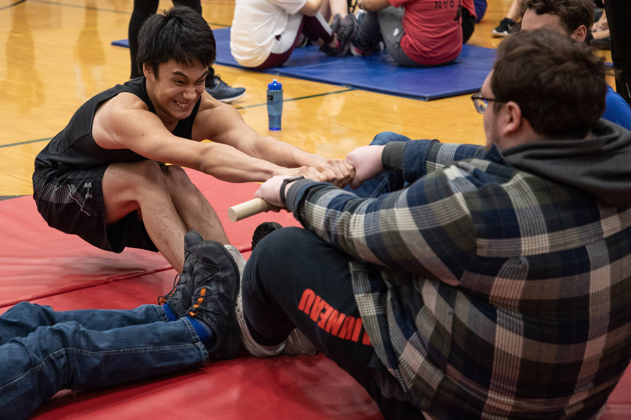 Bryan Johnson of Juneau shows effort on his face while competing in the Inuit stick pull at 2020 Traditional Games held Saturday and Sunday at Juneau-Douglas High School: Yadaa.at Kalé. (Courtesy Photo | Lyndsey Brollini, courtesy of Sealaska Heritage Institute)