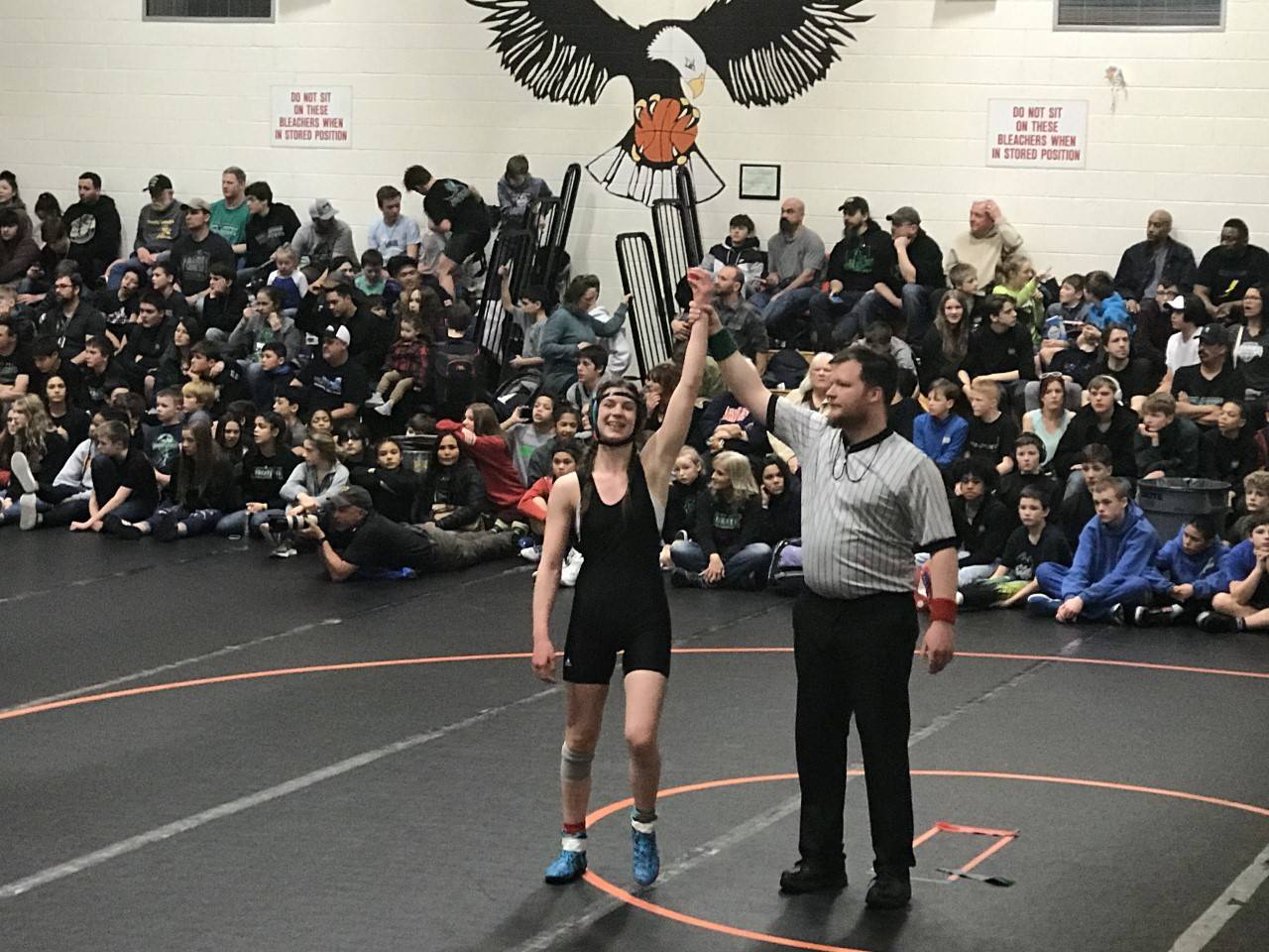 Courtesy Photos | Dana Richards                                 Above: Evelyn Richards stands with her arm raised following a match at the Middle School State Wrestling Championship in Fairbanks.