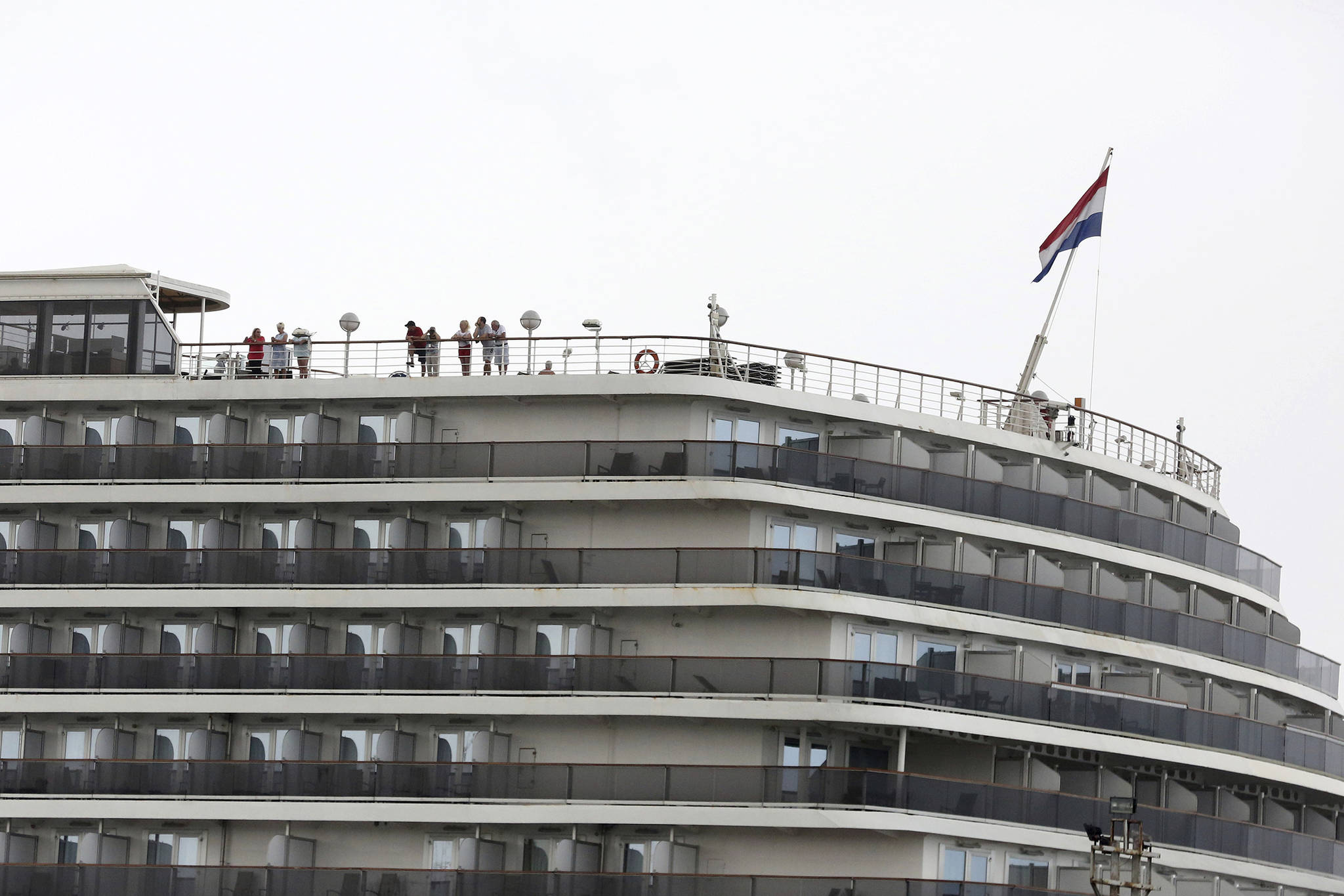 Passengers stand on the top deck of the MS Westerdam while the cruise ship is docked in Sihanoukville, Cambodia Monday, Feb. 17, 2020. (AP Photo)