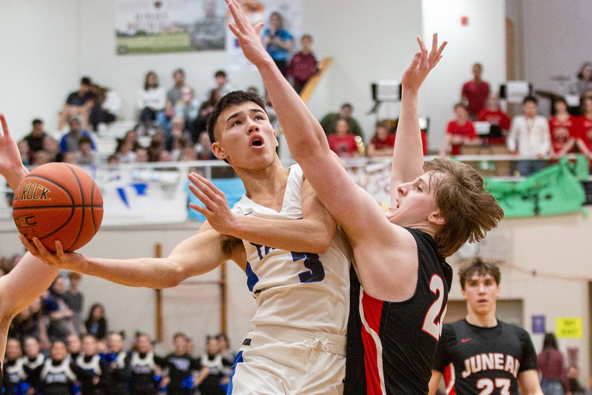 Courtesy Photos | Heather Holt                                TMHS’ Bryson Echiverri drives toward the hoop and is closely defended by JDHS’ Tad Watson in the Region V 4A championship game Friday at JDHS.