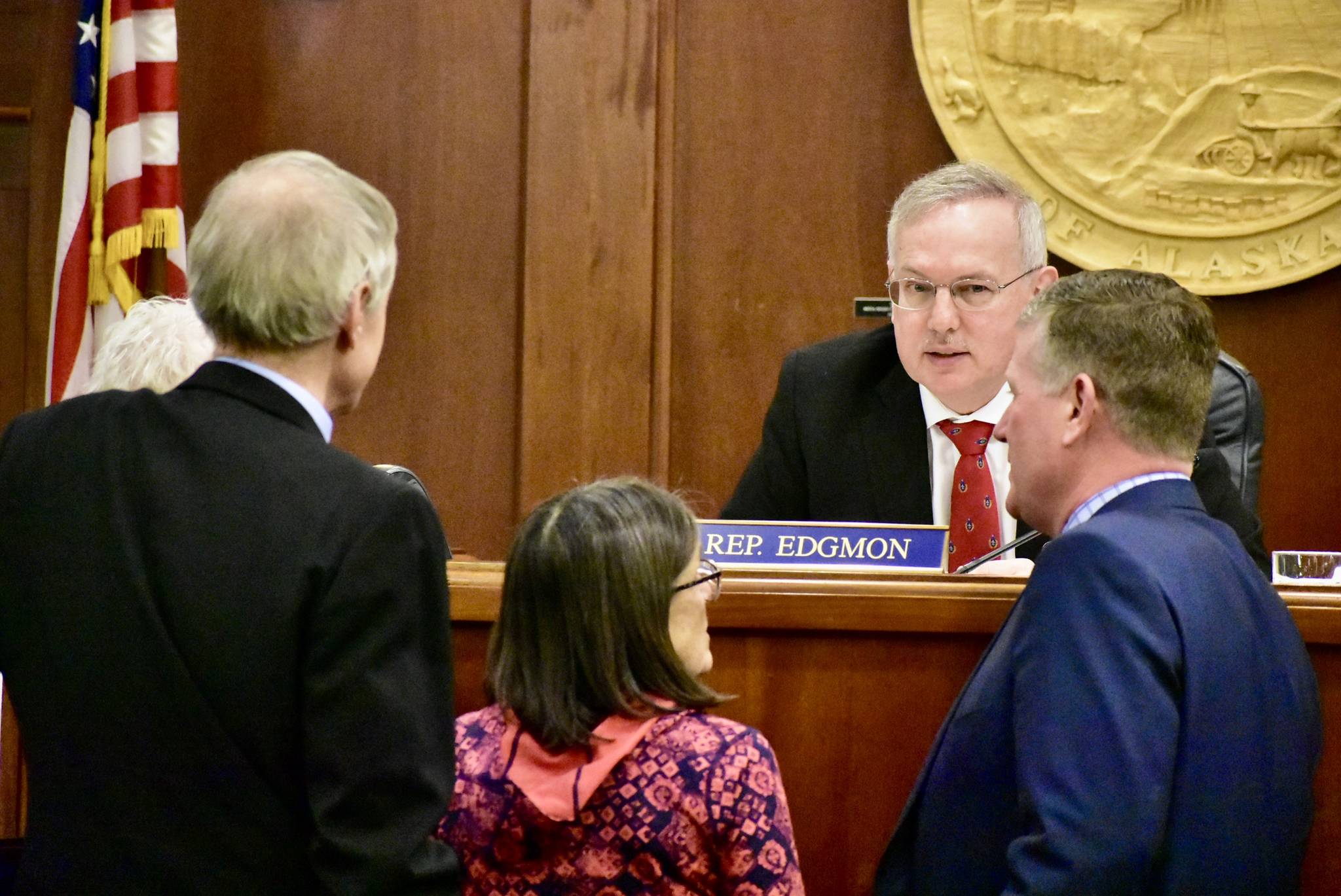 House Speaker Rep. Bryce Edgmon, I-Dillingham, seated, speaks with other members of the House during an at ease on Monday, March 16, 2020. (Peter Segall | Juneau Empire)