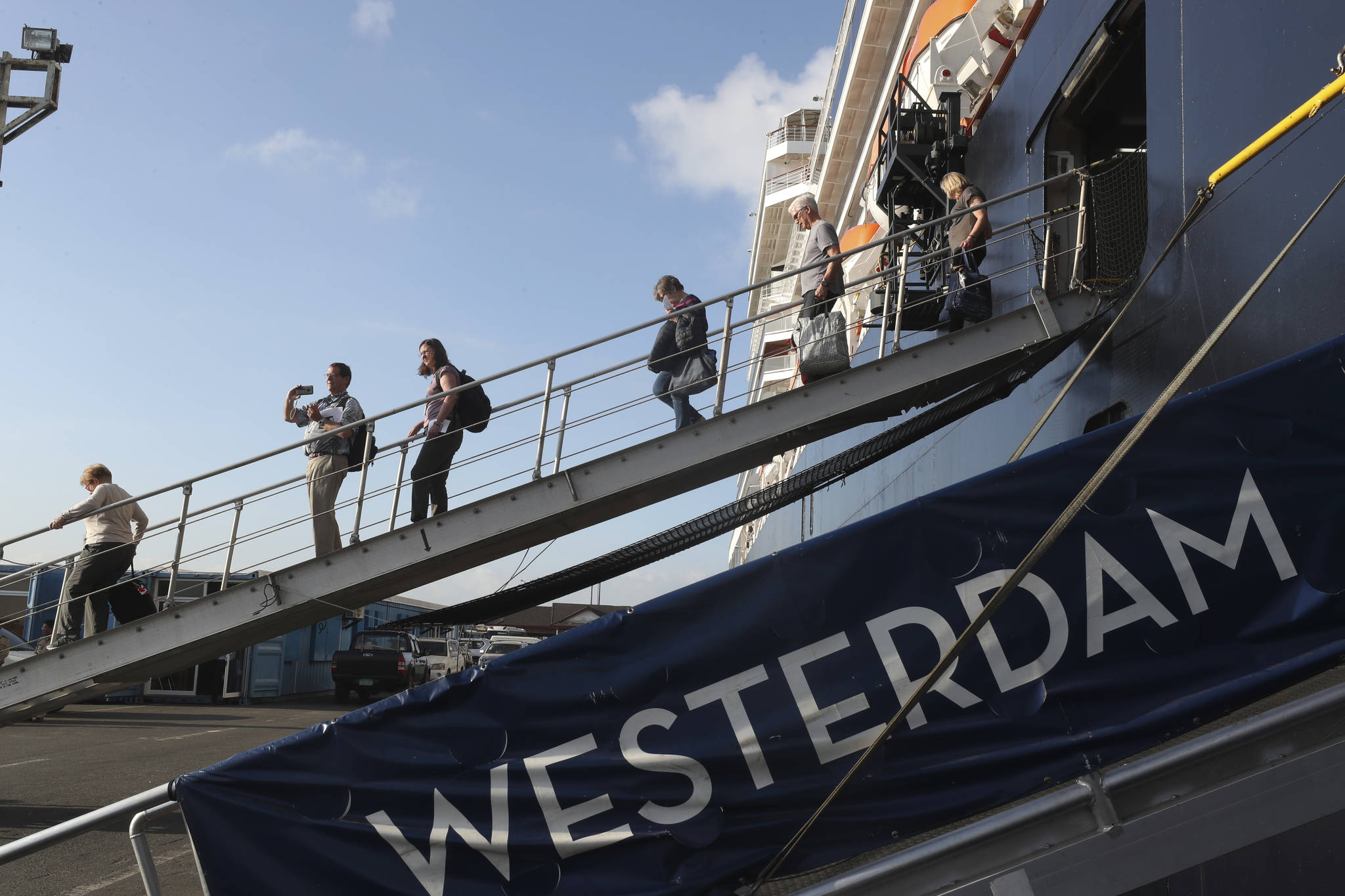 Passengers of the MS Westerdam, owned by Holland America Line, disembark from the MS Westerdam, at the port of Sihanoukville, Cambodia, last month. The ship was expected to come to Juneau, but instead it is heading to Mexico. (AP Photo | Heng Sinith)
