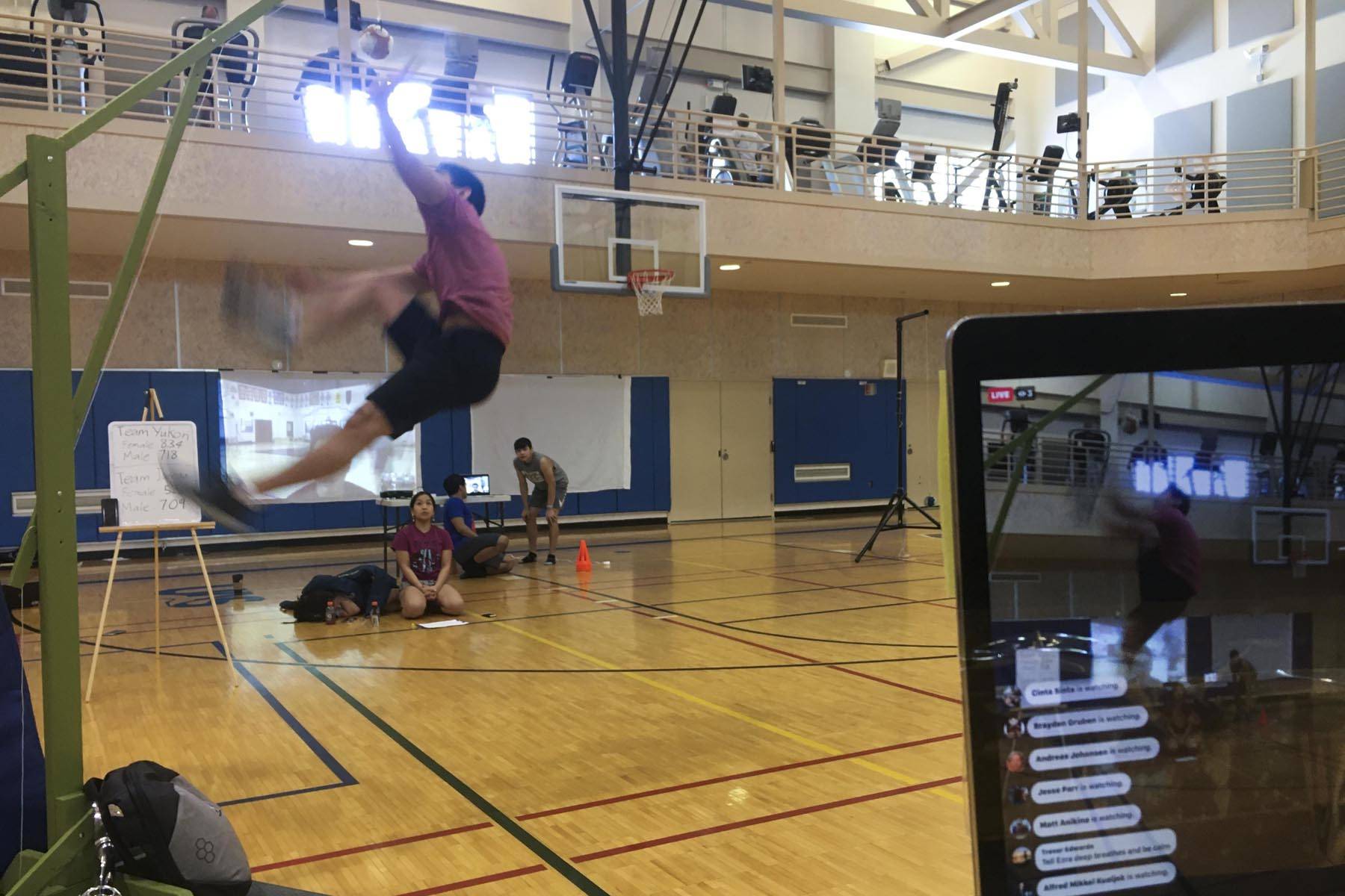 Matthew Quinto, a Thunder Mountain High School student, takes a shot at the one-foot high kick as members of Juneau’s Native Youth Olympic team compete against Whitehorse’s Team Yukon in a traditional games competition over livestreaming video at the University of Alaska Southeast rec center on March 17, 2020. (Michael S. Lockett | Juneau Empire)