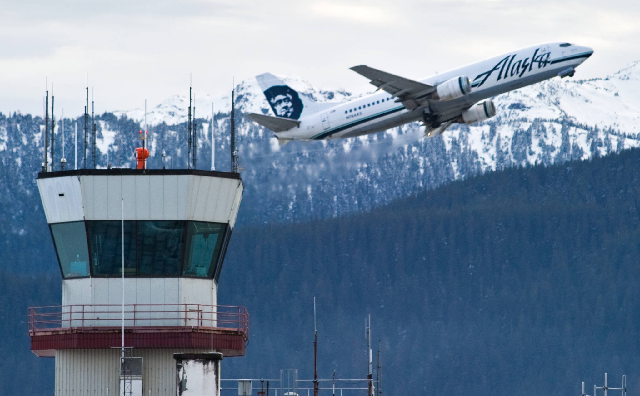 An Alaska Airlines cargo/passenger jet lifts off from the Juneau International Airport in this December 2014 photo. (Michael Penn | Juneau Empire File)