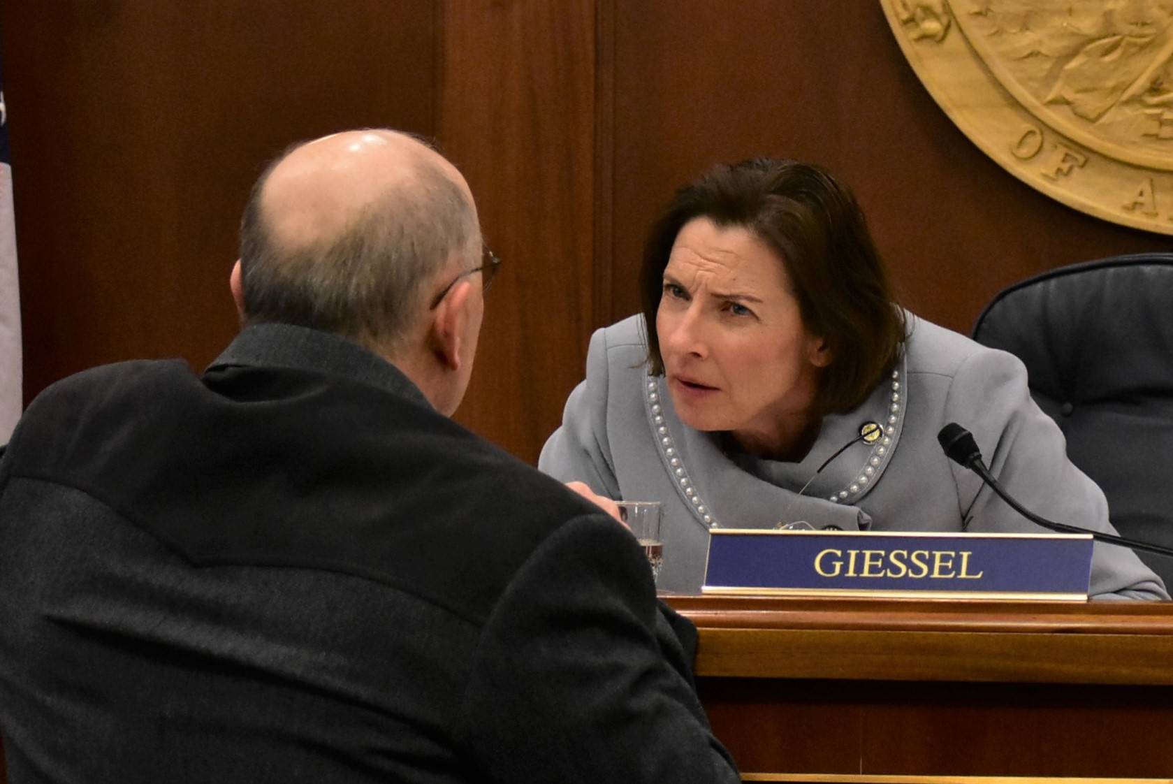 Senate President Cathy Giessel, R-Anchorage, speaks to Sen. Click Bishop, R-North Pole, on Monday, March 23, 2020. (Peter Segall | Juneau Empire)