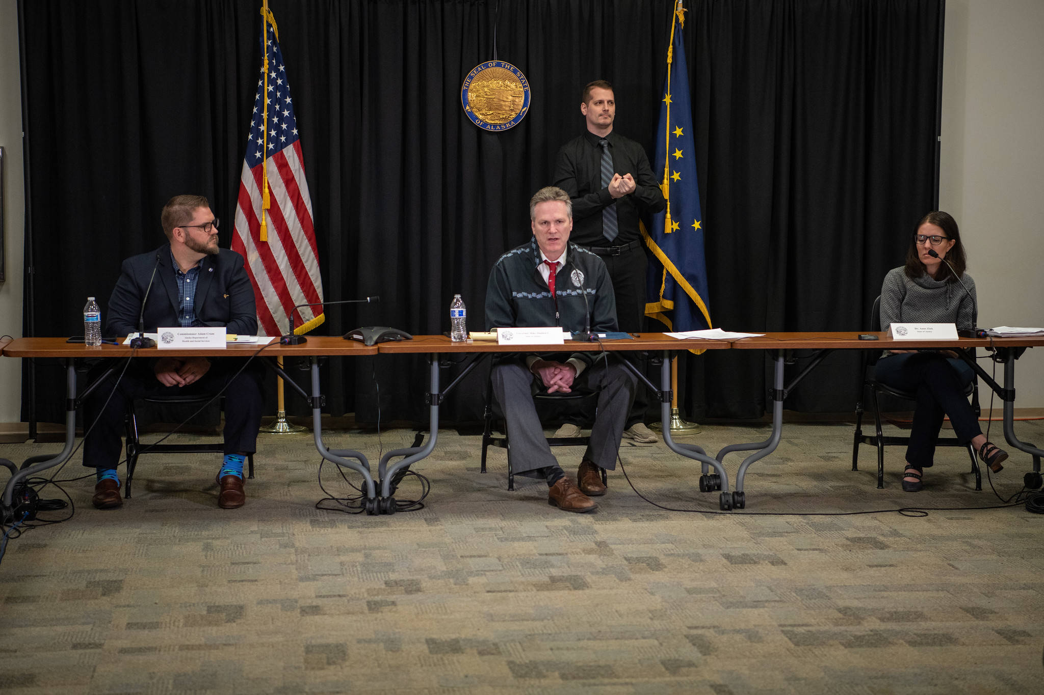 Seated, from left to right, Department of Health and Social Services Commissioner Adam Crum, Gov. Mike Dunleavy and Alaska Chief Medical Officer Dr. Anne Zink at a press conference in Anchorage on Wednesday, March 25, 2020. (Courtesy photo | Office of Gov. Mike Dunleavy)