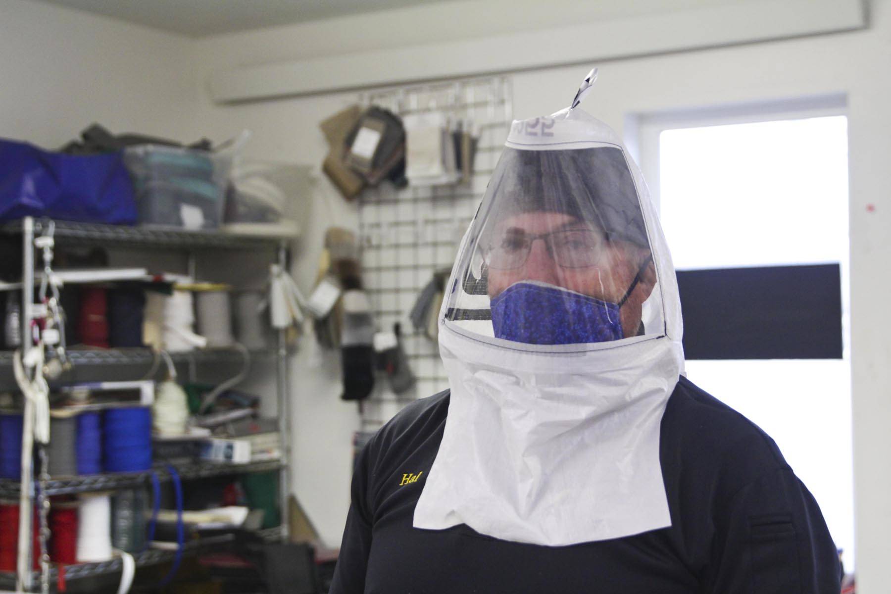Hal Daugherty shows off his hood design, to be put into production at his all-volunteer Southeast Regional Personal Protective Equipment Fabrication Facility, stood up in his sterilized workspace at Capital Canvas, March 27, 2020. (Michael S. Lockett | Juneau Empire)