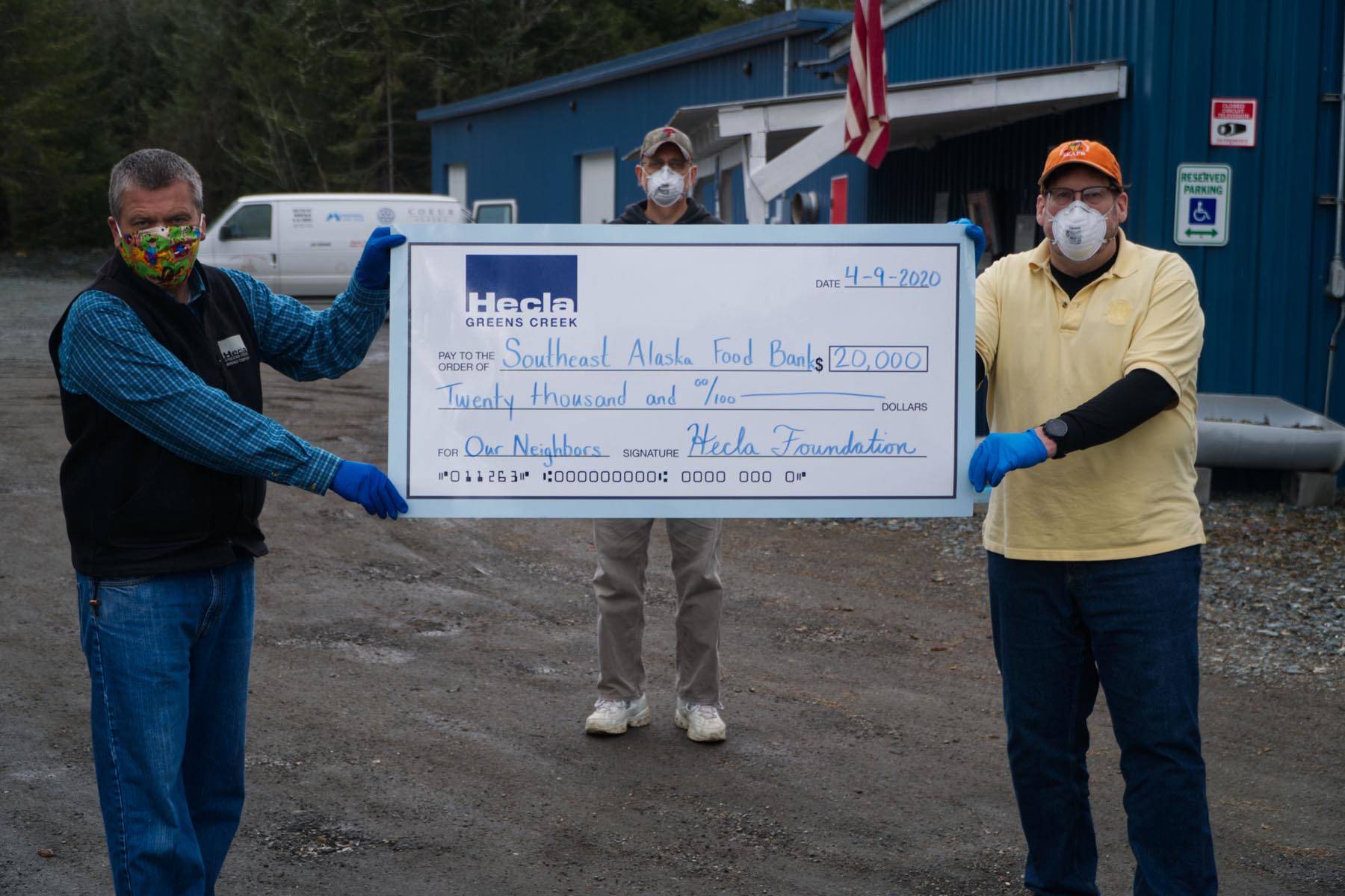 Mike Satre, left, Manager of Government and Community Relations at Hecla Greens Creek Mine, presents a $20,000 check to Chris Schapp, Manager, Southeast Alaska Food Bank, and David Lefebvre, Food Bank Board. (Courtesy photo | Hecla Charitable Foundation)