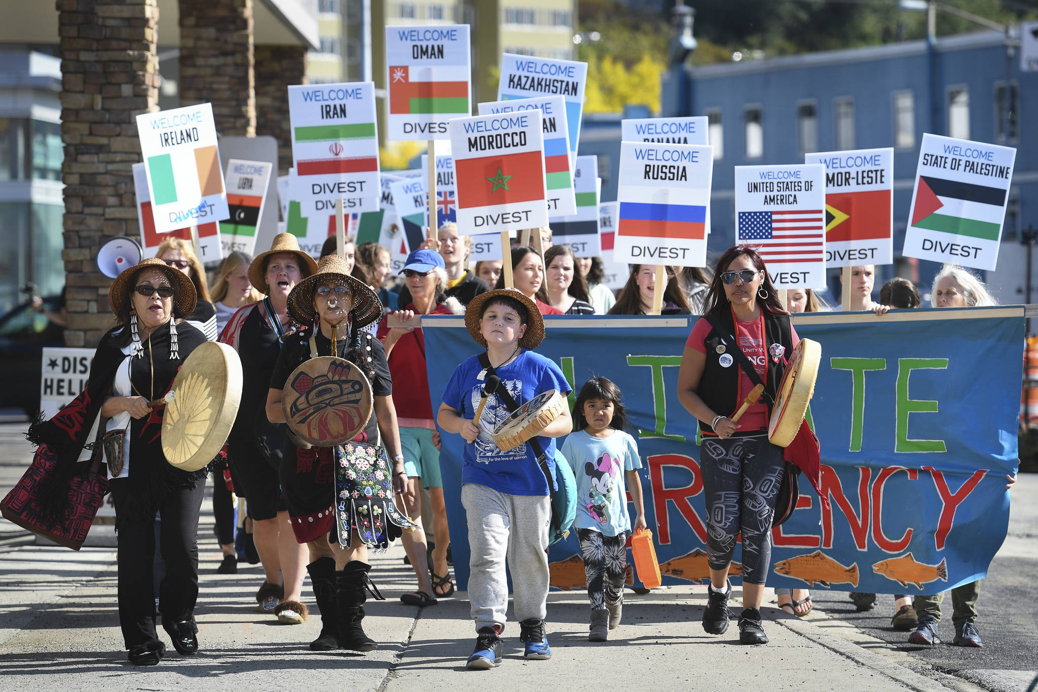 Juneau students and residents, led by members of the Yees Ku Oo Dance Group, march to Centennial Hall during a “Stand Strong for Climate” rally on Tuesday, Sept. 10, 2019. The International Forum of Sovereign Wealth Funds is holding four days of meetings at Centennial Hall. The rally was organized by 350 Juneau, a local chapter of an international climate advocacy movement, 350.org. (Michael Penn | Juneau Empire)