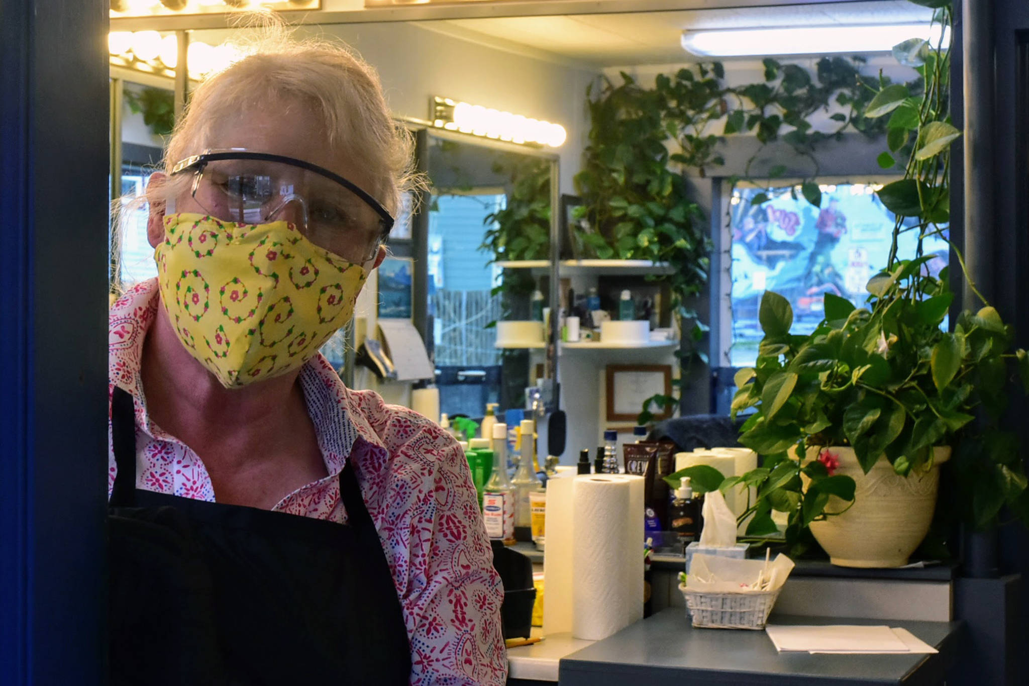 Mindy Roggenkamp, co-owner of Franklin Street Barbers, opened her doors Friday, April 24, 2020 even though she felt concerned it was happening so soon. She’s made her own facemasks, but still has trouble finding cleaning supplies and additional personal protective equipment such as gloves and plastic face shields. (Peter Segall | Juneau Empire)