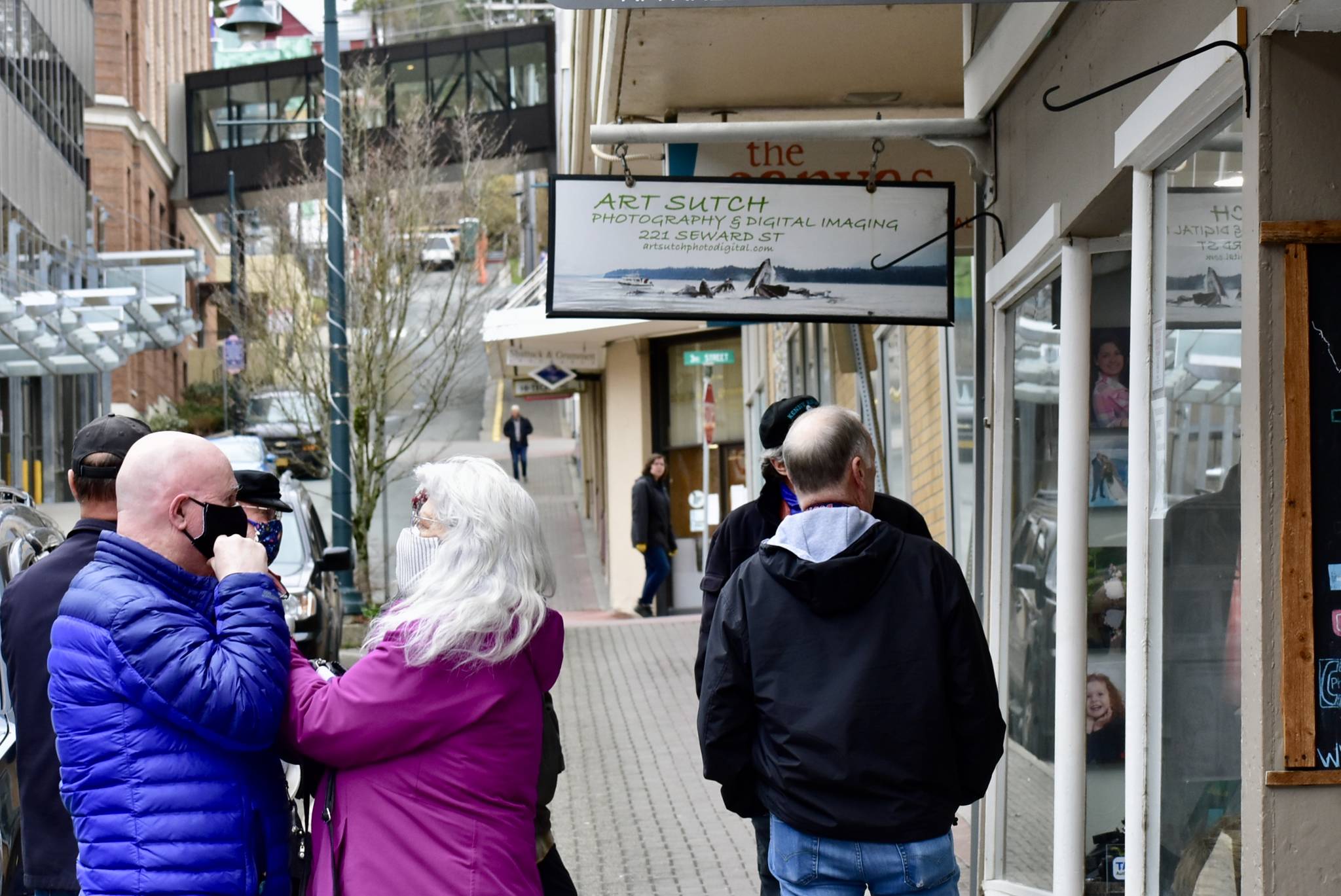 Patrons wait outside a shop in downtown Juneau on Friday, April 27, 2020. (Peter Segall | Juneau Empire)