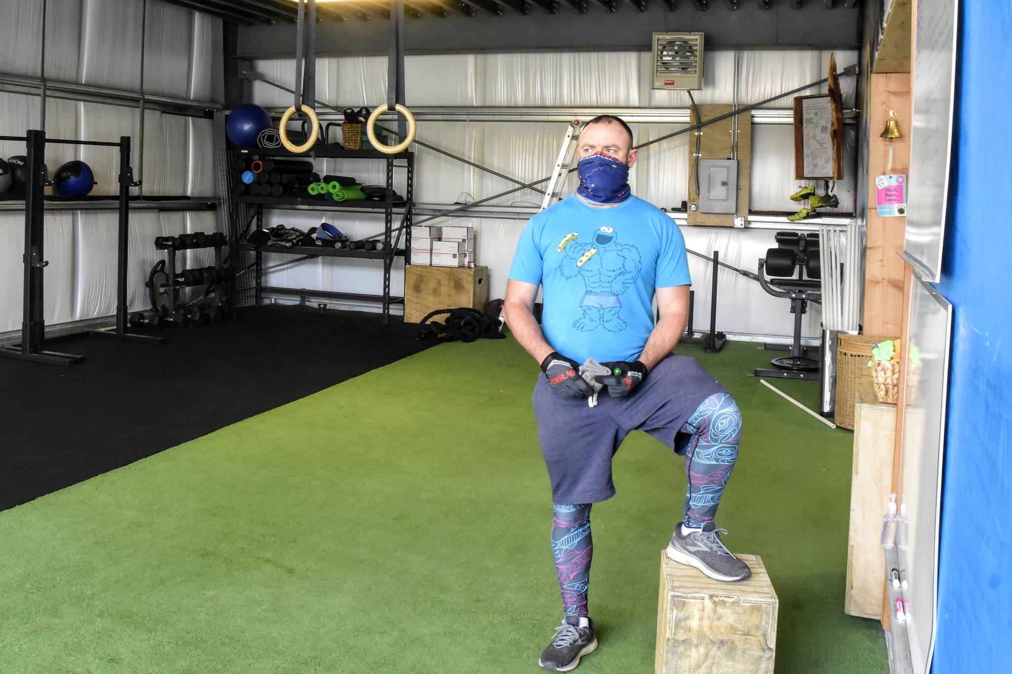 Logan Lott, owner of Tongass Fitness, prepares his gym Friday for its first customers in weeks, a group of four people. Lott said he had trouble finding state guidelines early, and hopes for additional clarification from the state on some of them.(Peter Segall | Juneau Empire)