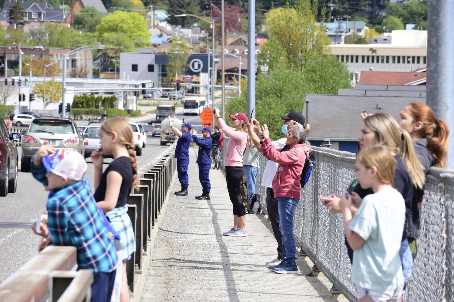 Spectators gathered on the Douglas Bridge to watch C-17 Globemaster III cargo planes from Joint Base Elmendorf-Richardson perform a flyby over Juneau on May 15, 2020, in support of the efforts of medical and emergency personnel in the face of the coronavirus. (Peter Segall | Juneau Empire)
