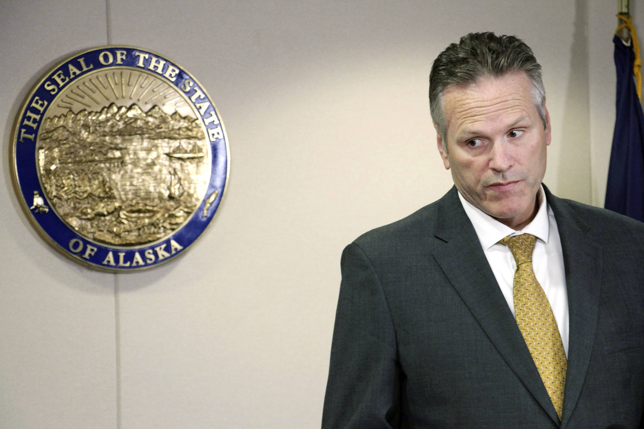 In this Sept. 26, 2019 file photo, Alaska Gov. Mike Dunleavy listens during a news conference in Anchorage, Alaska. The Alaska Supreme Court ruled Friday, May 8, 2020, that an effort to recall Dunleavy can proceed. (AP Photo | Mark Thiessen, File)