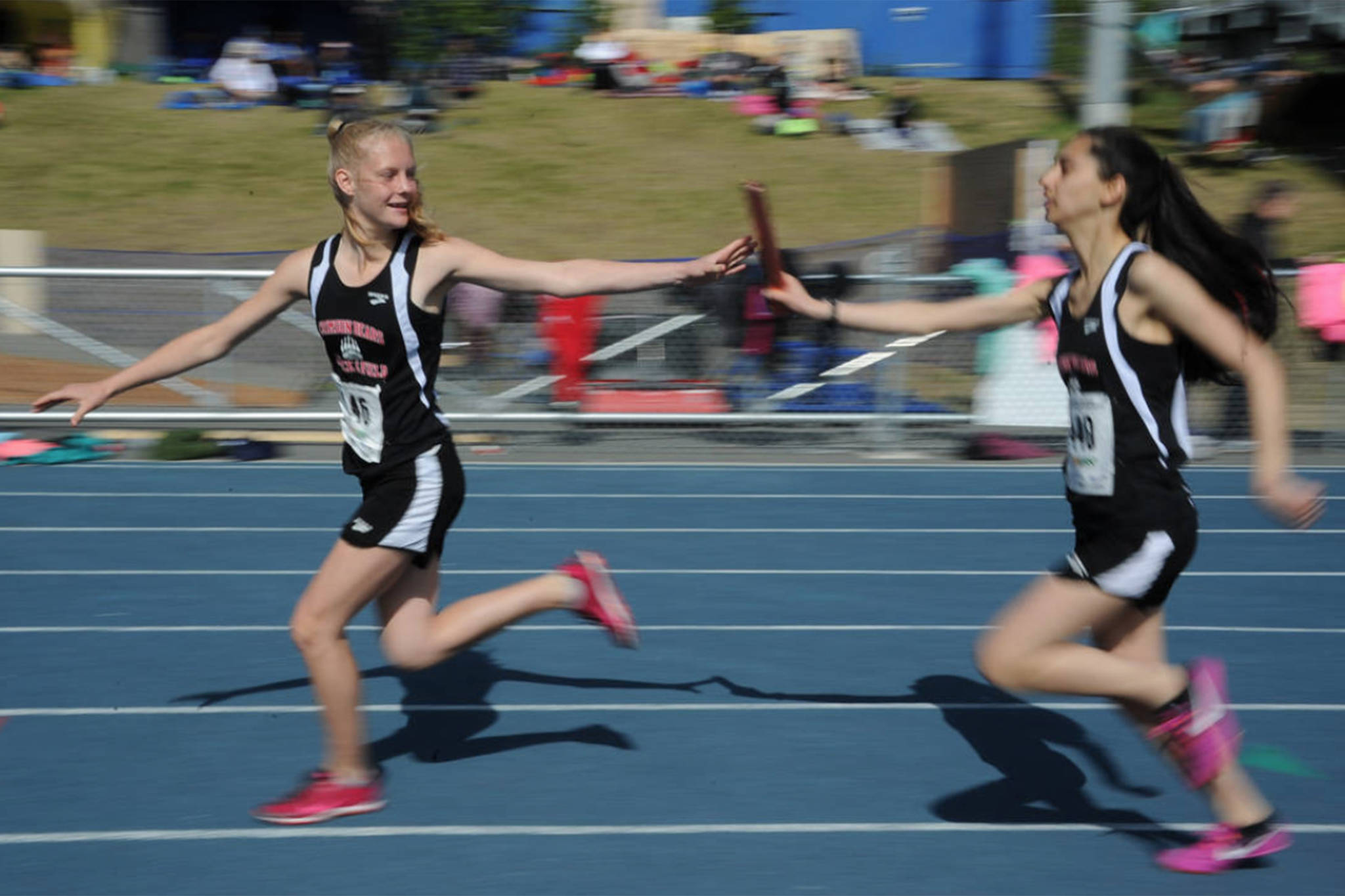 Sosan Monsef hands off the baton to teammate Sadie Tuckwood during the 2018 Alaska Track and Field State Championships. (Courtesy Photo | For JDHS Track & Field)
