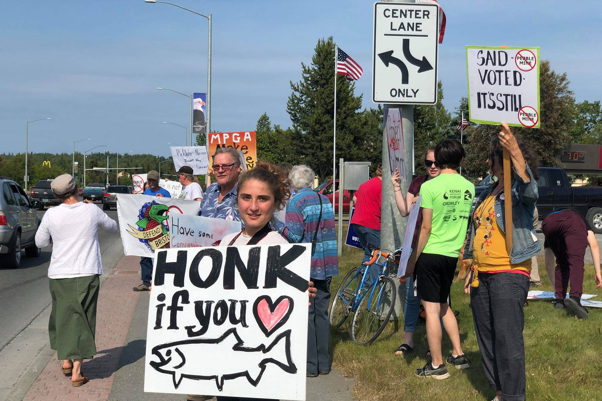 Residents line the Sterling Highway, in front of Sen. Lisa Murkowski’s office to oppose Pebble mine on Wednesday, June 26, 2019, in Soldotna, Alaska. (Photo by Victoria Petersen | Peninsula Clarion File)