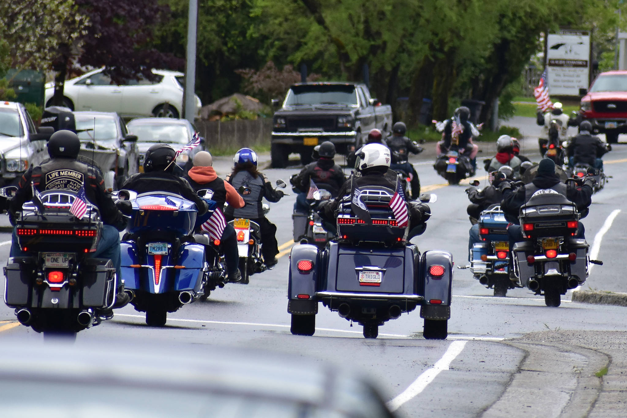 Members of the Southeast Alaska Tongass chapter of the Harley Owners Group head down Glacier Avenue past Juneau-Douglas High School: Yadaa.at Kalé on their way to Evergreen Cemetery for a moment of silence for deceased U.S. military members on Monday, May 25, 2020. (Peter Segall | Juneau Empire)