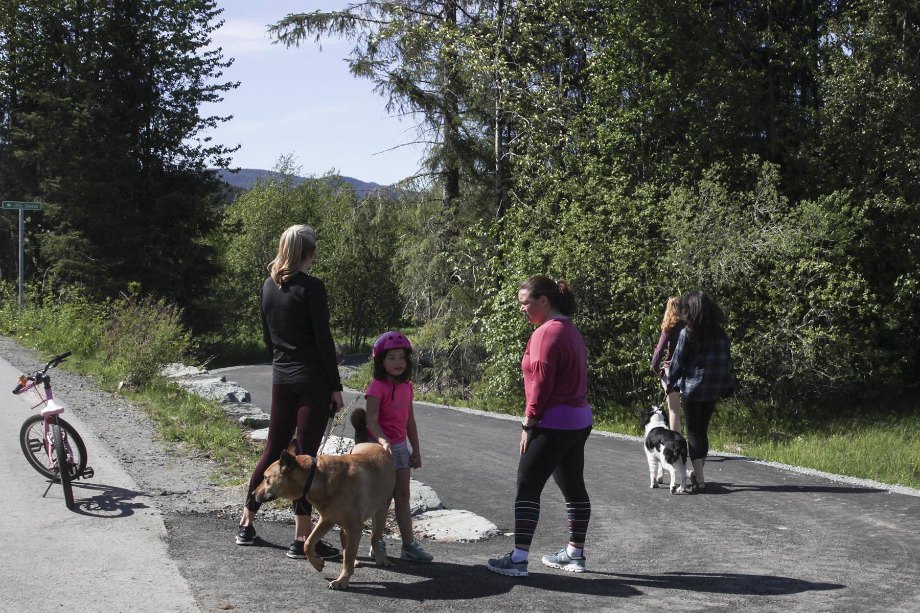 Juneau residents enjoy the newly repaved Kaxdigoowu Héen Dei (Brotherhood Bridge Trail) on May 27, 2020. The trail has been moved, repaved, and reopened after riverbank erosion threatened the original trail. (Michael S. Lockett | Juneau Empire)