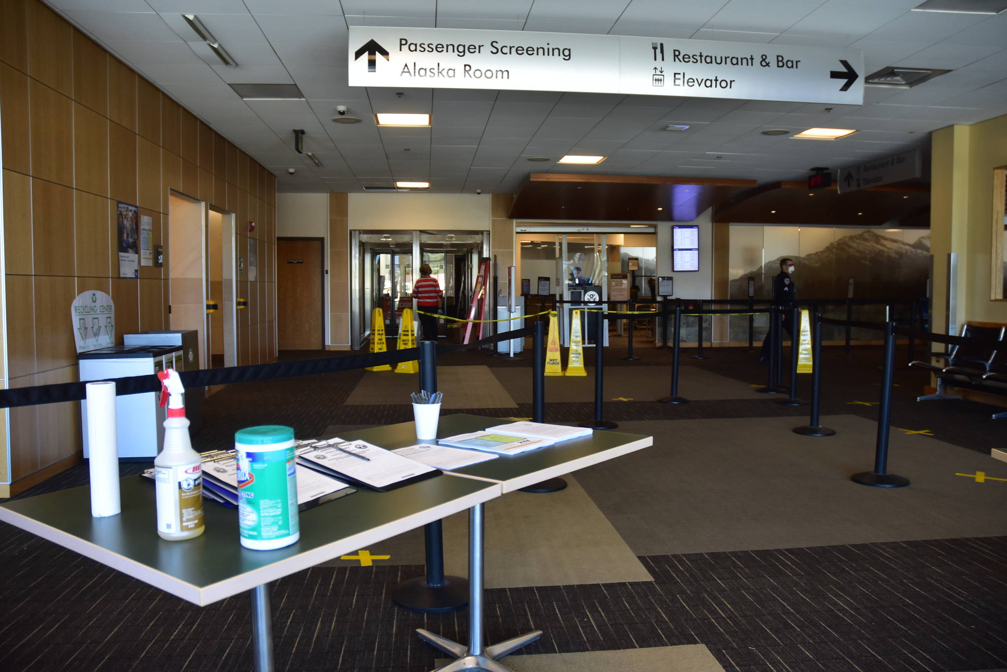 Sanitary supplies and declaration forms laid out for out-of-state travelers arriving at the Juneau International Airport on Wednesday, May 27, 2020. The 14-day, self-quarantine mandate is set to end June 5 but there will still be requirements for interstate travelers. (Peter Segall | Juneau Empire)