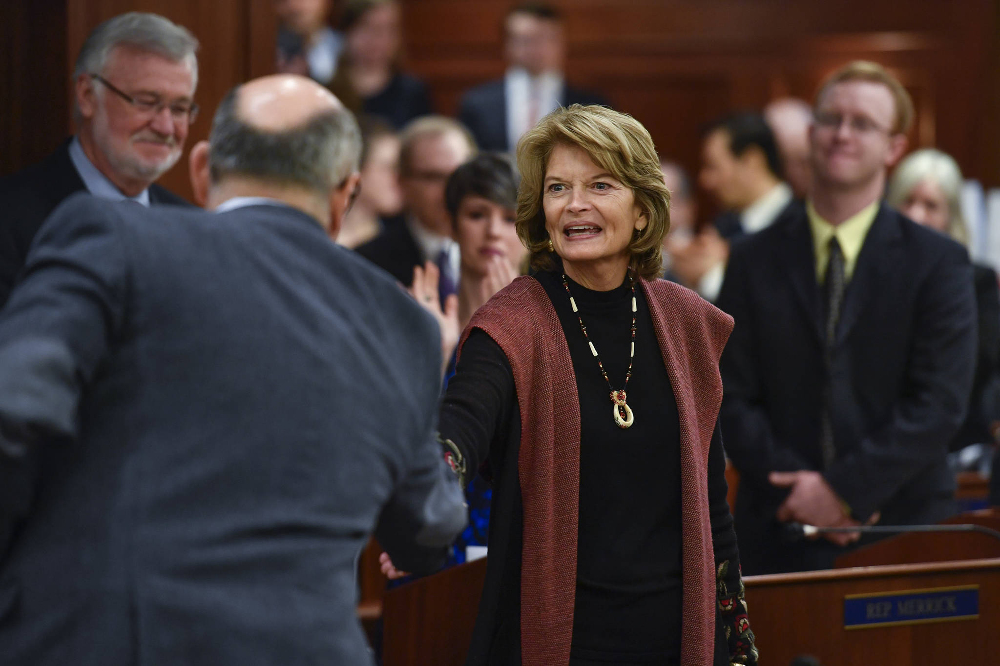 U.S. Sen. Lisa Murkowski, R-Alaska, greets legislators as she arrives in the House chamber for her annual speech to a Joint Session of the Alaska Legislature on Tuesday, Feb. 19, 2019. (Michael Penn | Juneau Empire File)