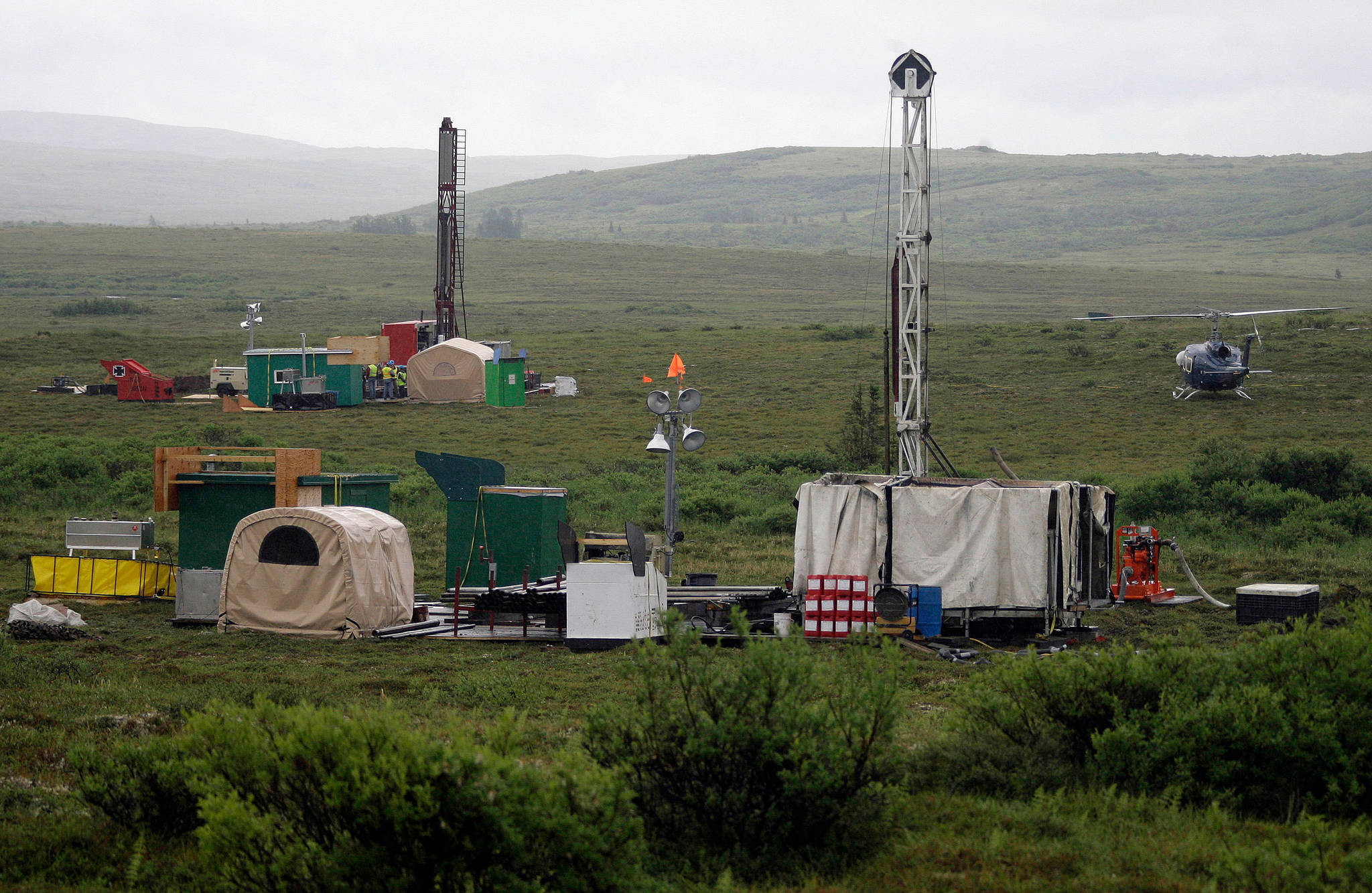 In this July 2007 photo, workers with the Pebble Mine project test drill in the Bristol Bay region of Alaska, near the village of Iliamma. The Pebble Limited Partnership, which wants to build a copper and gold mine near the headwaters of a major U.S. salmon fishery in southwest Alaska, says it plans to offer residents in the region a dividend. (AP Photo | Al Grillo, File)