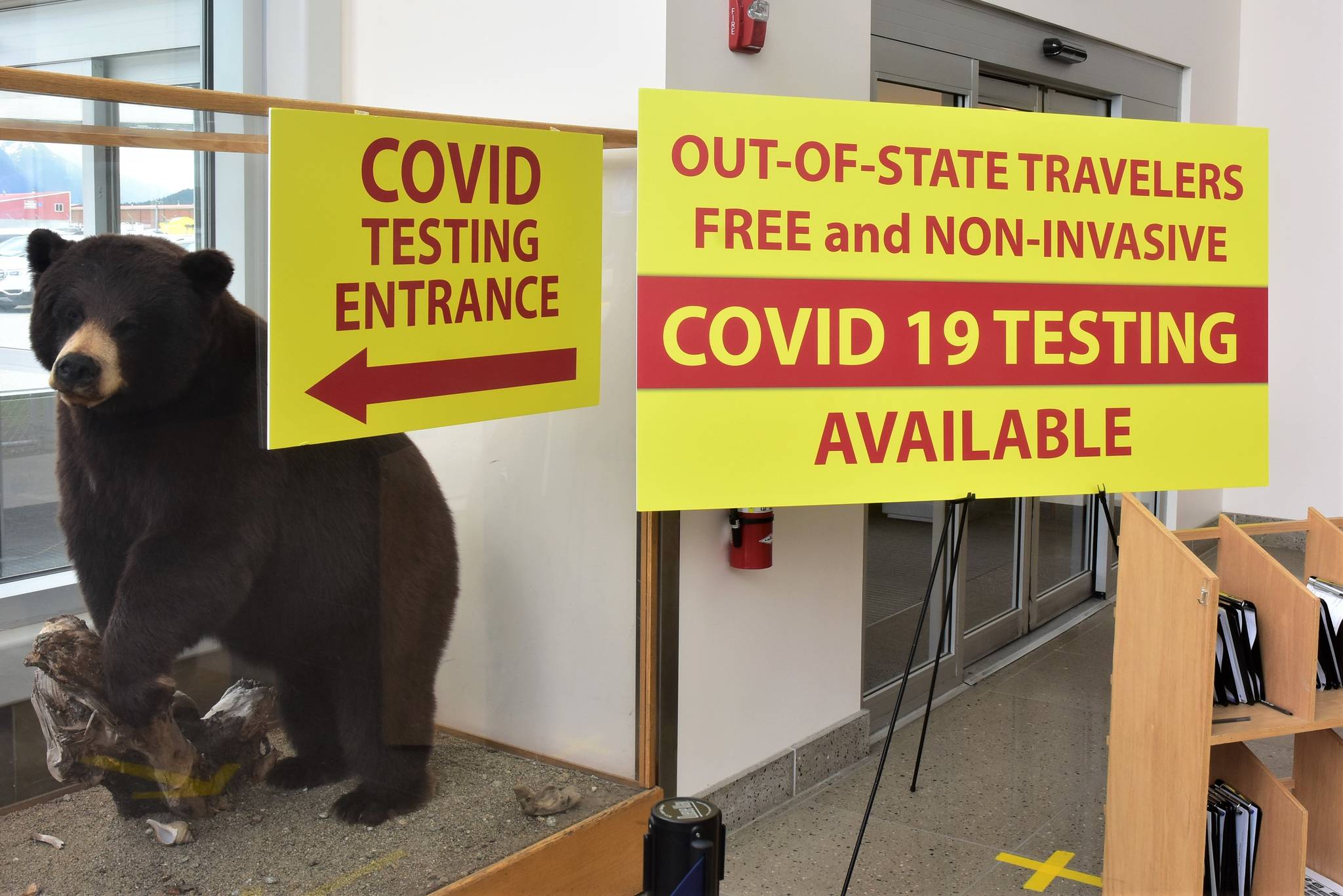 A sign at Juneau International Airport directs out-of-state arrivals to COVID-19 testing services in order to comply with Alaska’s travel mandates, on Wednesday, June 24, 2020. As travel increases and cases rise, some are calling for mandates requiring cloth face coverings that they say have been proven to limit the spread of respiratory viruses. (Peter Segall | Juneau Empire)