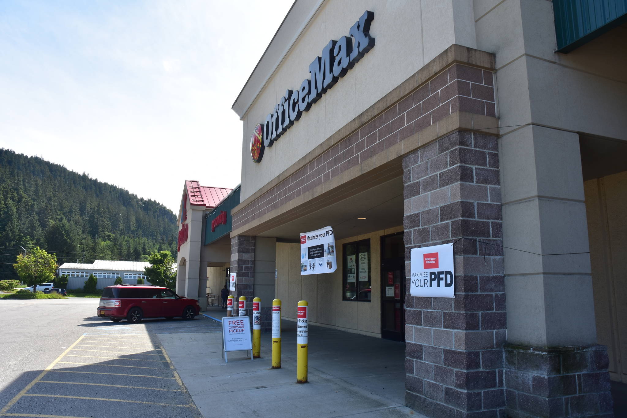 Signs advertise Permanent Fund Dividend sales in front of Office Max at the Nugget Mall in the Mendenhall Valley hason Thursday, July 2, 2020. (Peter Segall | Juneau Empire)