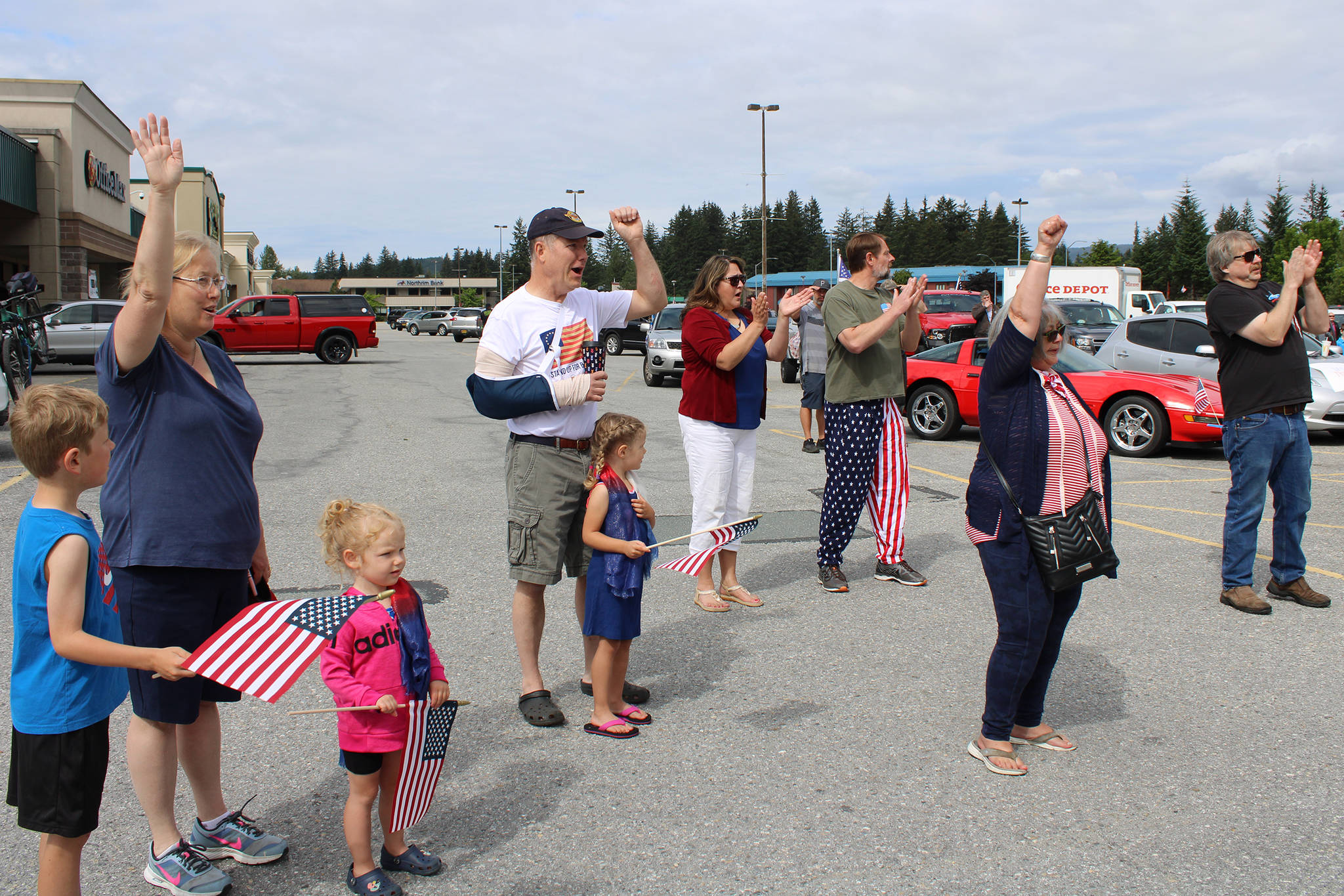 People cheer following the Pledge of Allegiance prior to the start of a parade July 4, 2020. (Ben Hohenstatt | Juneau Empire)