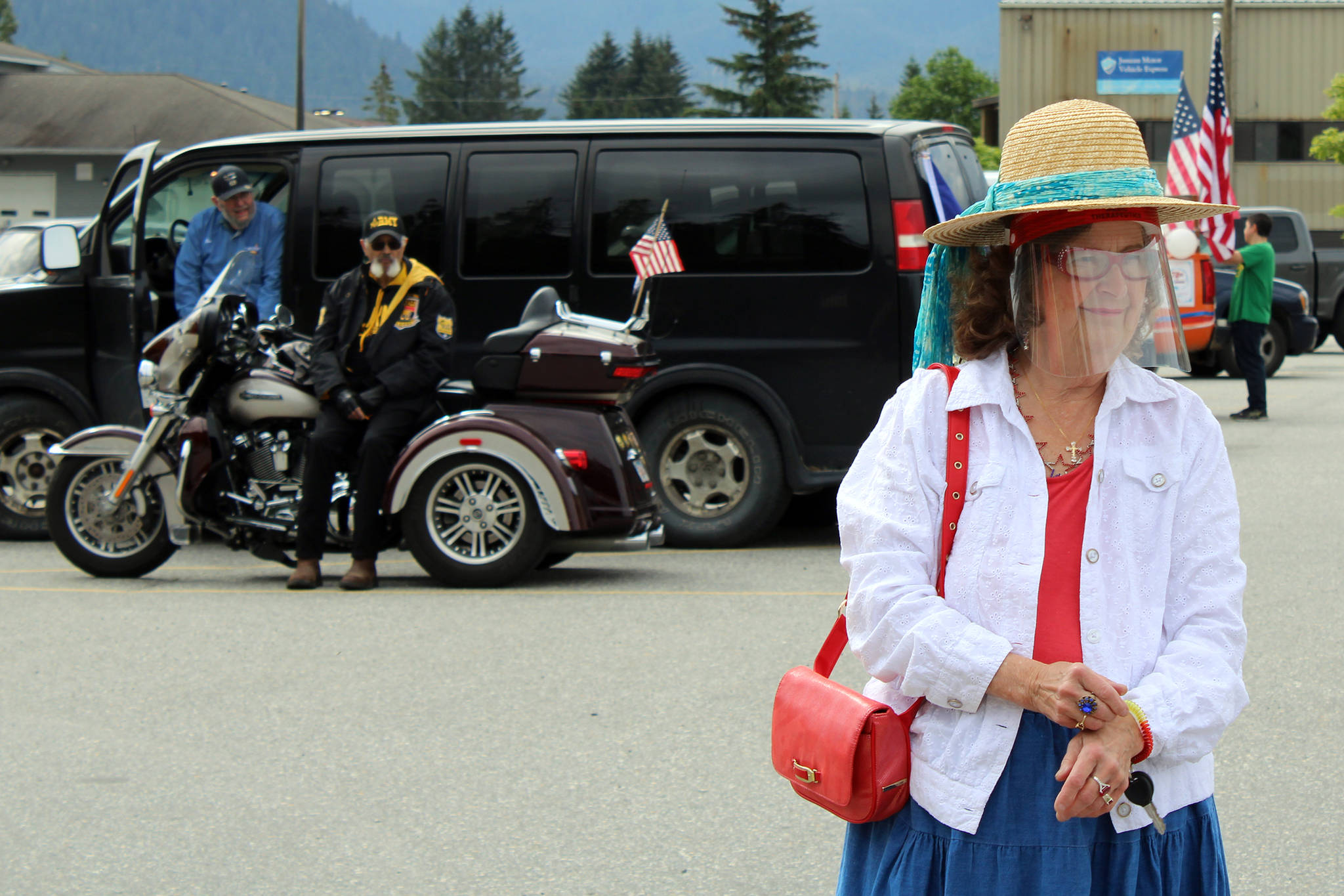 Suzanne Haight dons a hat and face covering in the parade staging area prior to a parade Saturday, July 4, 2020. (Ben Hohenstatt | Juneau Empire)